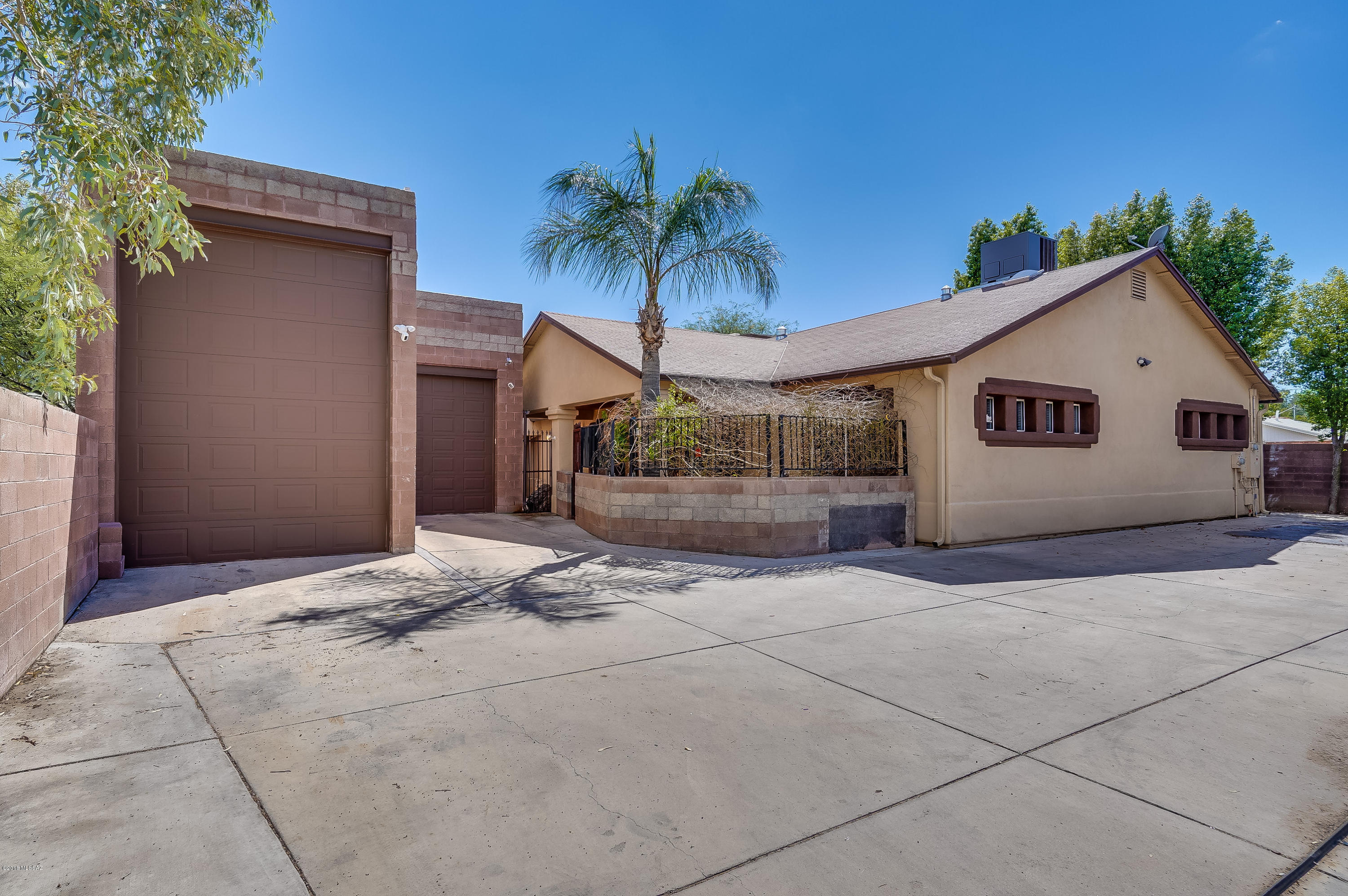 U of A Central Turn Key Investment property!  Senior care or student housing with annual gross income of $38,000/ year. Rents are $450-650 /month with room to raise, 3.5 miles to U of A w/bus stop across the street! This massive 5,500 sq/ft home offers very large bedrooms with high dramatic ceilings & walk-in closets, 2 huge master suites, all updated bathrooms and kitchen, scored concrete floors, gym/game room leading to outdoor BBQ/kitchen, pool & spa! Low maintenance costs, $100 TEP bill/ month, with $60K Solar owned equipment,, R.V /boat /toys garage, iron gate, security camera & Not in a flood zone! Bring your buyers today!