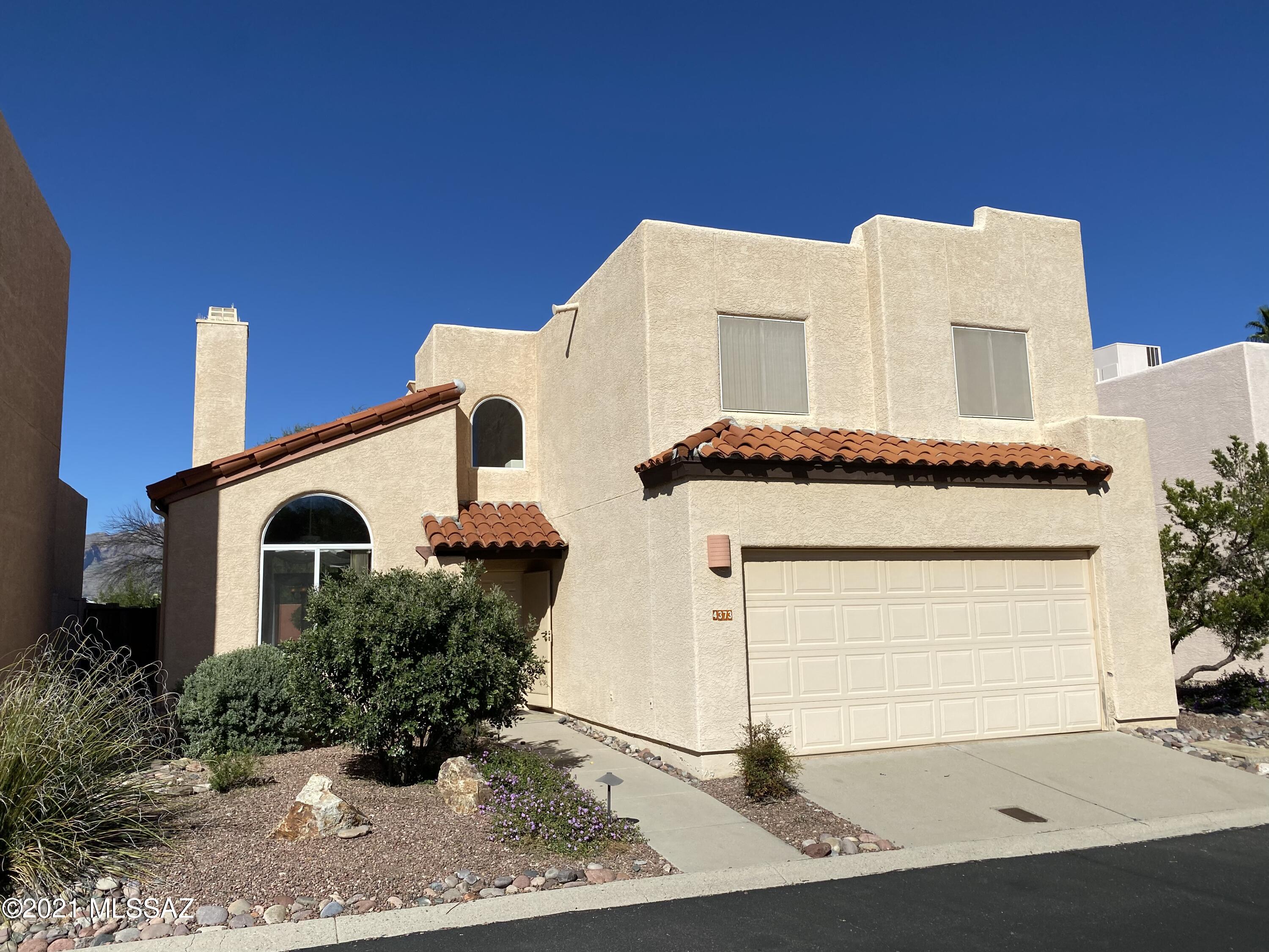 Beautiful 2-story home with southwest charm situated on a premium lot with mountain views from the owner's suite and backyard. Primary features include 3-bedrooms + Den, 2.5 baths, 2-car garage with epoxy flooring, soaring ceilings in the great room, and a modern gourmet kitchen with stainless steel appliances and breakfast bar that opens up to the living room. The flexible loft space upstairs can be used as an in-home office, den, or playroom. Granite countertops throughout and Venetian plaster in the owner's suite, powder room, and fireplace. Town & Country is a highly sought-after neighborhood with a community pool and close proximity to Tucson's famous Rillito River path! Easy access to downtown, U of A, and some of the best restaurants and shopping in Tucson.