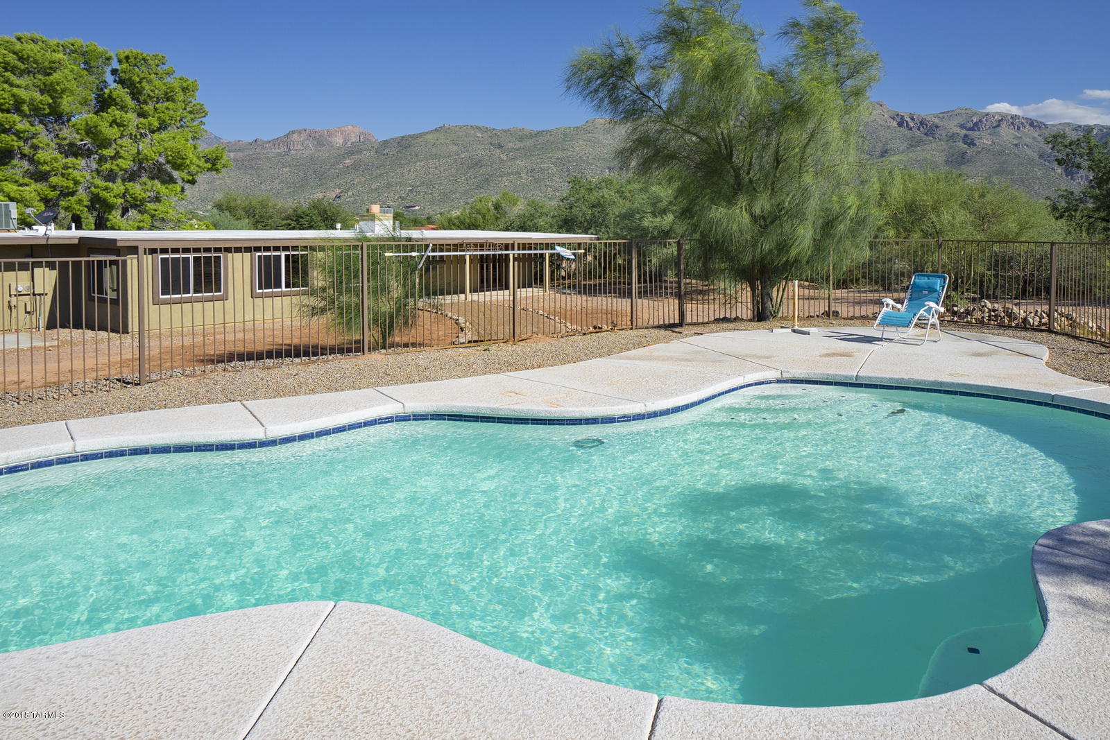 SELLER WILL ACCEPT OR COUNTER OFFERS BETWEEN $400,000 & $425,000. This home was completely remodeled in 2014.  The main house includes 4 bedrooms plus a Den (or 5 bedrooms), a new kitchen, new tile floors and updated bathrooms.  The kitchen features granite counters, glass tile, SS appliances and is open to the living spaces. Family room has a stone fireplace.  The windows in the Arizona Room bring in tons of light and look out to the back yard and pool. You have Catalina and Rincon Mountain views from both front and back. The property also includes a GORGEOUS 800 sq ft guest house. The guest house has higher ceilings, a large living room and bedroom, a kitchen with full size refrig and microwave and stovetop.  Bathroom has custom tile and a large walk-in shower.