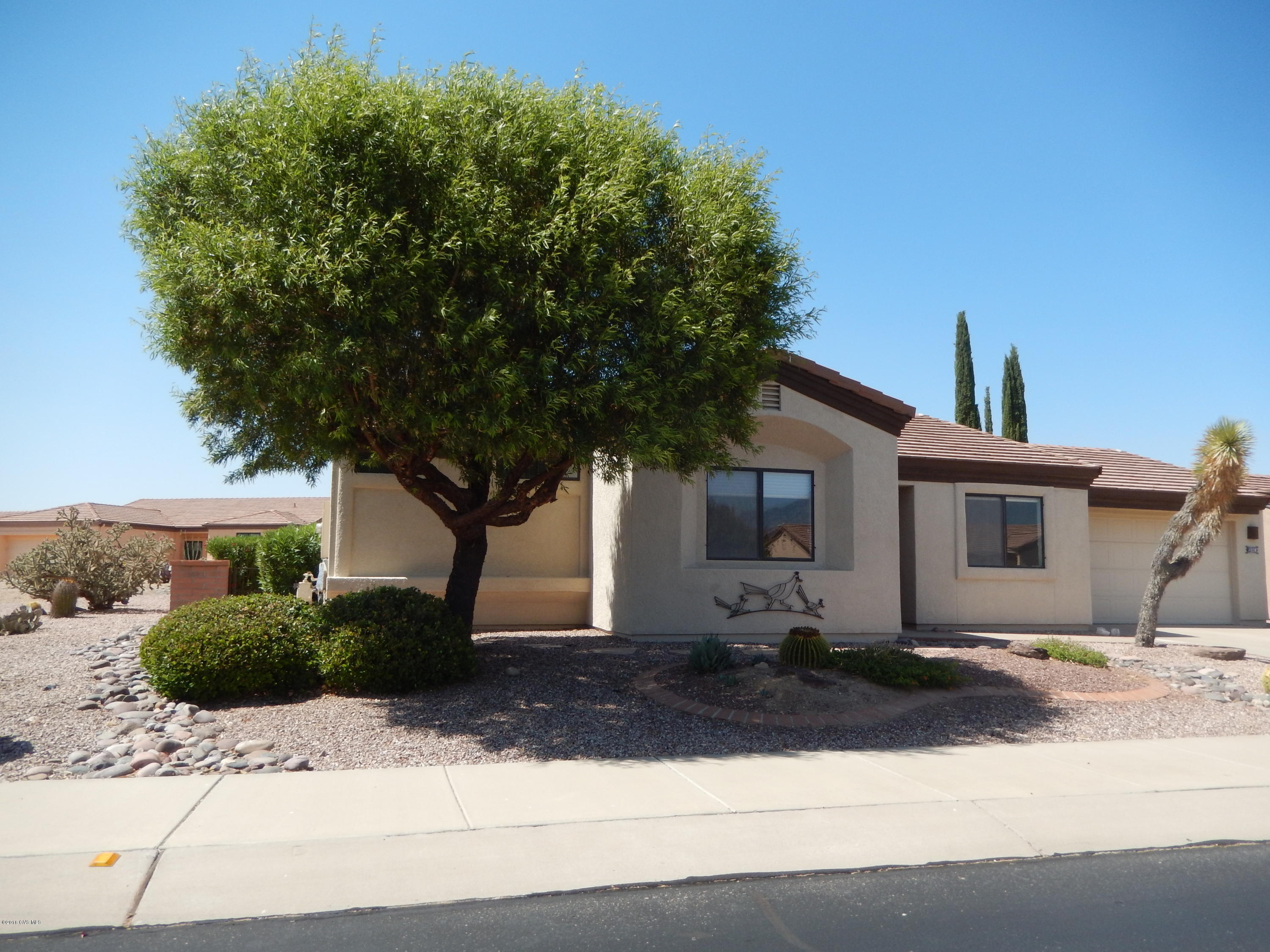 This ''spic and span'' home is ready for you to move in and make your own! Beautiful tile floors thruout and located on a large corner lot. 2BR/2BA with 2-car garage and extra storage. Lovely screened back porch and covered area for BBQ with gas stub. Convenient pass thru from kitchen to dining area or enjoy the breakfast nook with mountain views.