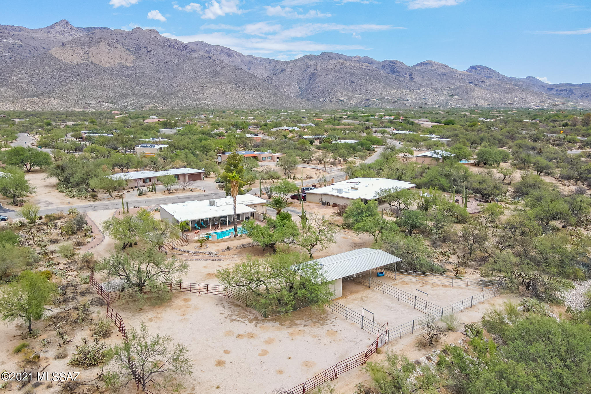 Desirable Tanque Verde Valley Horse Property with Facilities (Tack Room, Round Pen, and 2 covered Horse Stalls).  Gorgeous Mountain Views, No HOA, Dual Cooling, Storage/Workshop in garage, fantastic full-length covered patio and sparkling pool with diving board, outdoor shower, split bedroom plan, u-shape driveway for horse trailer, plenty of space for your RV/Boat/Toys.  Well loved and maintained home just waiting for you.