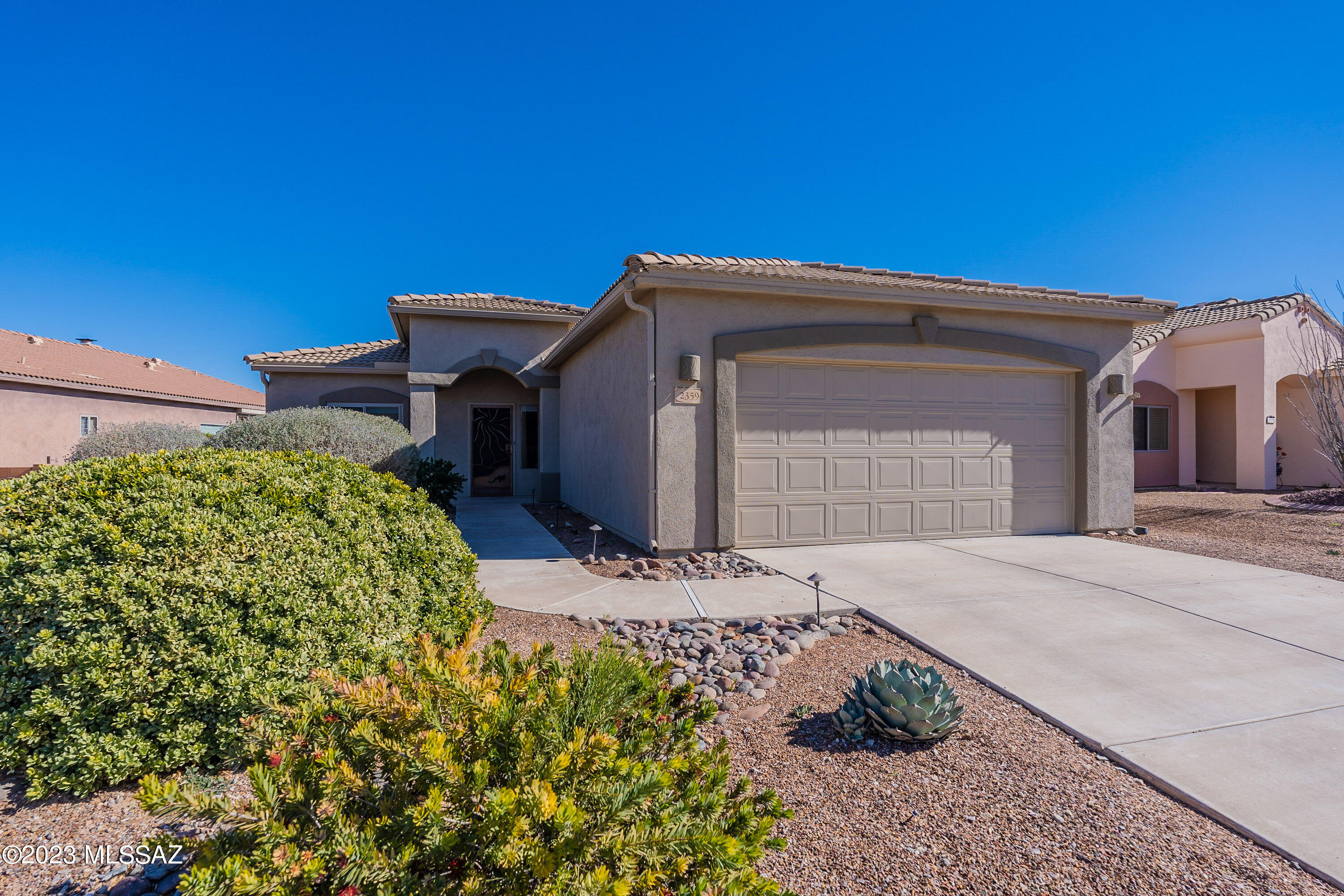This ''Masterson floor plan'' is super-efficient and has lots of storage closets too!    You will find tile floors throughout the home for easy care.  The colorful southwest tones take you to the open and kitchen with recessed can lighting, serving bar and an abundance of cabinetry and countertop space.  The extended patio has roll down screens which provide a wonderful extended outdoor living area.  The large yard can provide several different seating areas for you to enjoy views of the Santa Rita Mountains from your paver patios.  Located in a gated community which also offers a community swimming pool!