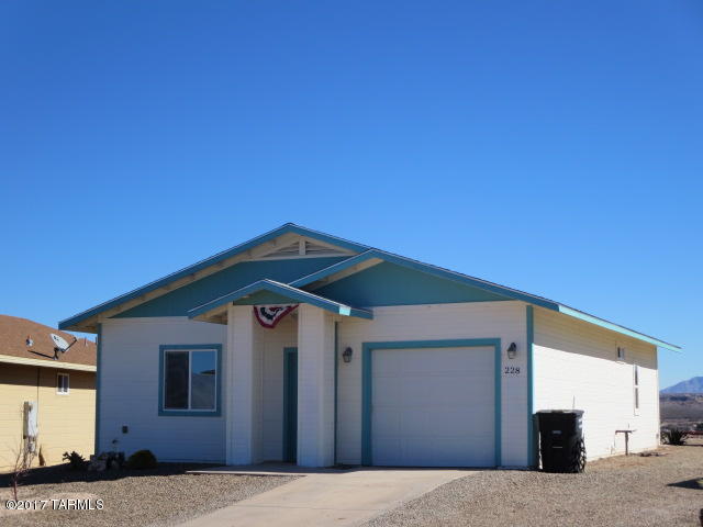 Nice 2 bedroom 2 bathroom site built home on top of a hill in downtown Benson with expansive views to the east of the San Pedro River Valley. Contemporary style home with split bedrooms, open floor plan and easy care concrete floors throughout. There is an attached 1 car garage and a separate golf cart garage with adjoining carport that could also make a great workshop or use for storage. Plus a full RV Hookup with easy parking. This house is move in ready!