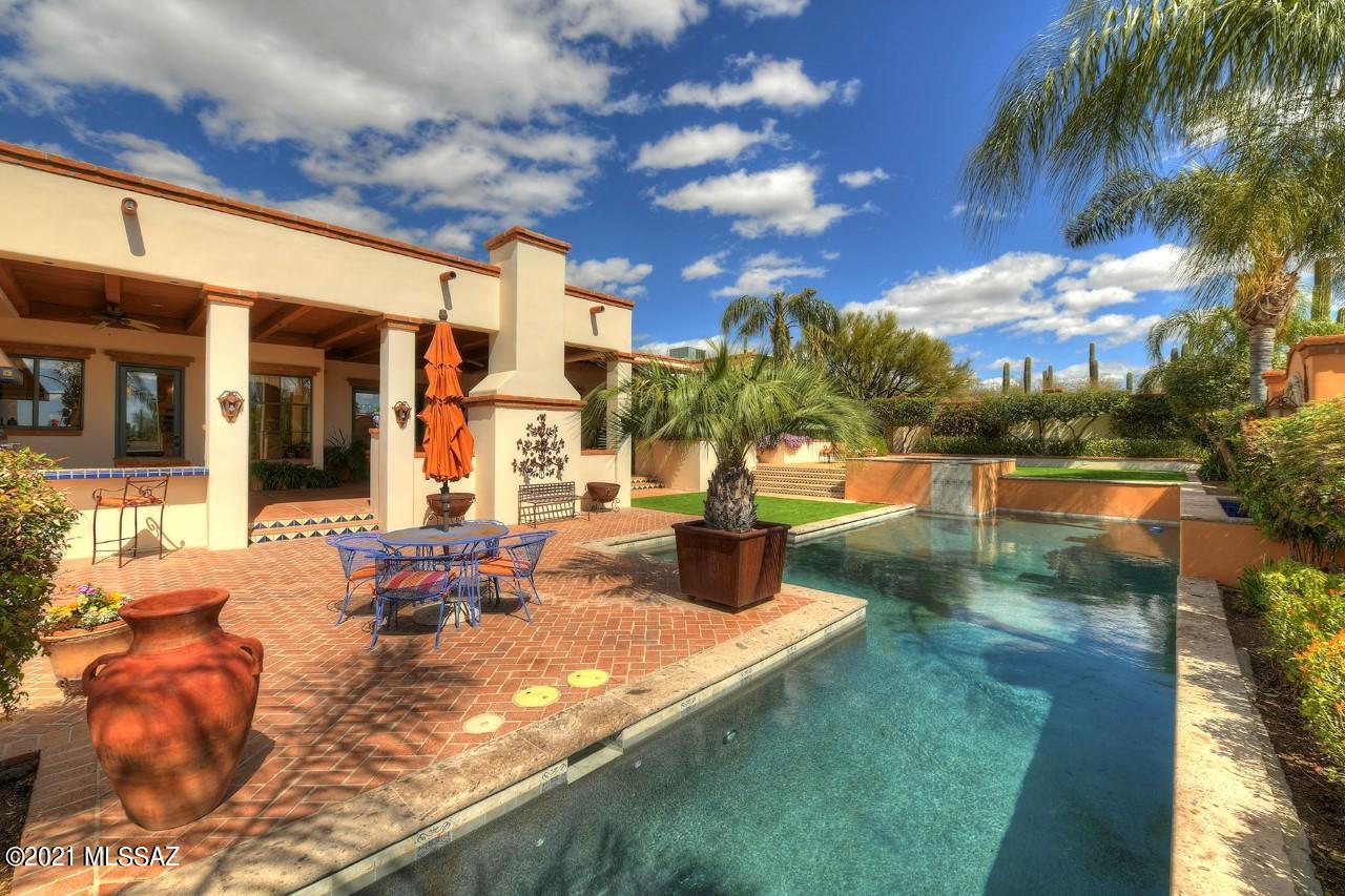 This home has everything.  A great location in the Old Foothills, just one street East of the River/Campbell intersection; close to excellent restaurants, shopping, La Encantada and the U of A.  This is a perfect home for entertaining or just enjoying the many patios or relaxing by the  pool.  This is a classic Jed Paradies territorial with casual elegance and with all the amenities for today's lifestyle. This masonry stucco masterpiece features a North/South orientation. The home's 3152 square feet includes a spacious Living/Dining room with 13 foot plank and beam ceilings and a gas fireplace.  A few steps up from the Living room is the large master bedroom retreat with wood burning fireplace, walk-in closet, master bath with jetted tub and separate shower.  There are two private patios off the master bedroom, one facing North and one facing South. The eat in kitchen is a cook's dream with 48 inch, dual fuel Wolf range with 6 gas burners and a griddle and 2 convection ovens.  The Sub Zero refrigerator, 2 dishwashers, microwave, warming drawer, custom cabinets from Arizona Designs Kitchen & Baths and quartz countertops, blue and white Portuguese tiles complete this fantastic space. Off the kitchen is a lovely family room/den with 11 foot plank and beam ceilings. Bedrooms 2 and 3 share a charming Jack and Jill bathroom.  There is easy access to an adorable half bath from the kitchen and family room. The expansive back patio runs the length of the home.  This beautiful oasis includes an outdoor kitchen, a spacious seating area in front of a wood burning fireplace, beautiful pebble tec lap pool and spa, cantera stone fountain, & large planting areas. The scored concrete flooring complete this lovely space.