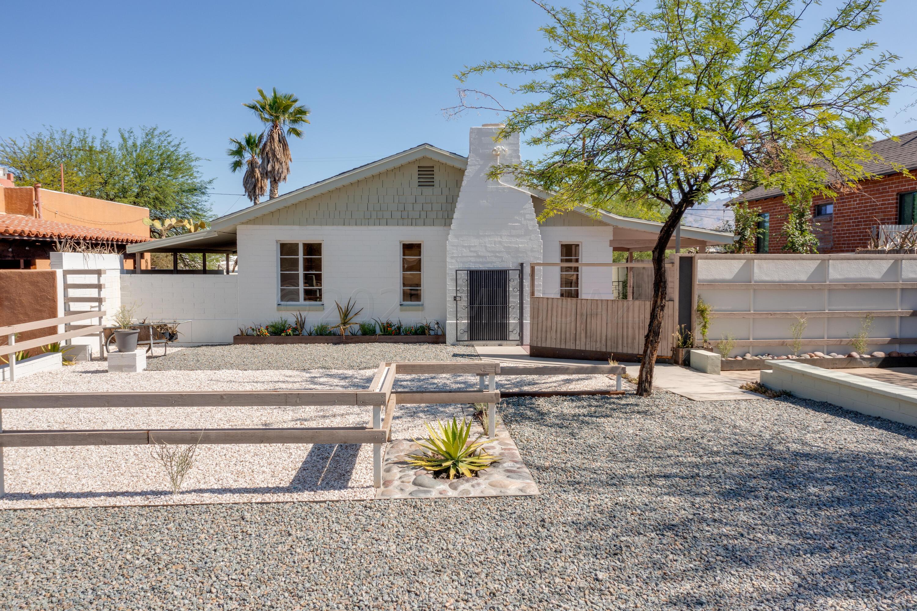 Mid-Century Classic home with a fresh color palette is located in the desirable Sam Hughes Historic Neighborhood. This 5 Bed, 2 1/2 baths of living/work space is creatively arranged to utilize the outdoors to its fullest while remaining very low maintenance. The renovated house and guest house promote that sought after work from home lifestyle, the ideal vacation rental/retreat. A walled compound within walking distance of the UofA that is also situated on a designated bicycle route is just moments away and why people move to Tucson. Plenty of off-street parking, a carport, canopy structure for a shade sail, separate laundry facility for guest house, manicured and well lit private entry for guest house.
