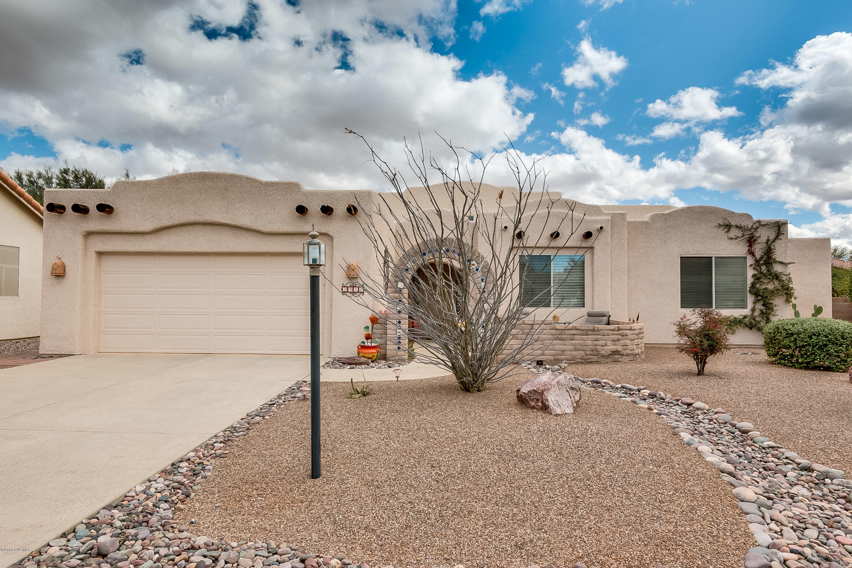 Talk about the WOW factor! This home has been so thoughtfully laid out and just shines. If you are looking for southwest design and comfortable living, you will not be disappointed. Lots of natural light with celestory windows and skylights, when evening comes, there are plenty of lights including accent lighting at the pot shelves close to the living room ceiling. Interior finishes include ''Saltillo'' tile, designer paint colors, surround sound in all rooms but mother in law suite. The great room has a floor to ceiling entertainment center/fireplace with niches for your collectibles. Enter the patio from the living room, master bedroom or guest casita and enjoy the Santa Rita Mountain views! The desert breezes are welcomed to the home from the security screen doors at the front,  master bedroom and guest casita. The garage has epoxy floors, built in cabinetry, a built in work bench, celestory windows, whole house humidifier, and a refrigerator.