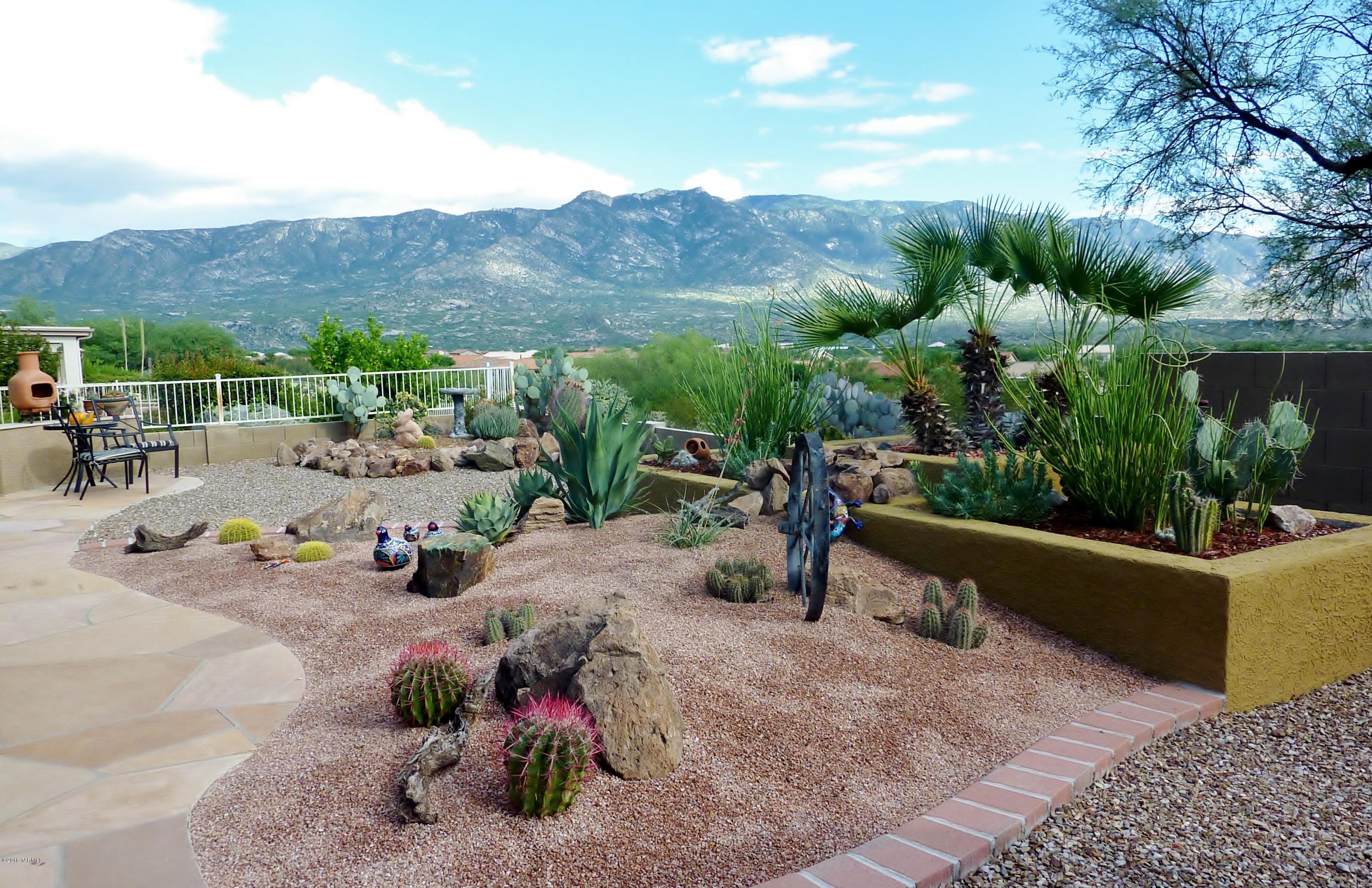 Spectacular Mountain Views! This Customized Estancia floor plan with walls and columns removed shows like a model home, creating a fabulous great room feel. The great room has an expansive wall of picture windows looking out to the amazing Catalina Mountains. Beautiful granite kitchen countertops, maple cabinets with pullouts, custom window treatments, beautiful tile, light fixtures and natural colors throughout. Spacious bedrooms, a gorgeous guest bath with granite and a vessel sink. Front and back landscaping has a WOW factor, perfect for entertaining & enjoying outdoor living. Rear patio has a south exposure backing up to natural desert and a distant golf course view. Enjoy the active adult lifestyle in Saddlebrooke, a community where you can enjoy many amenities, activities and dining.