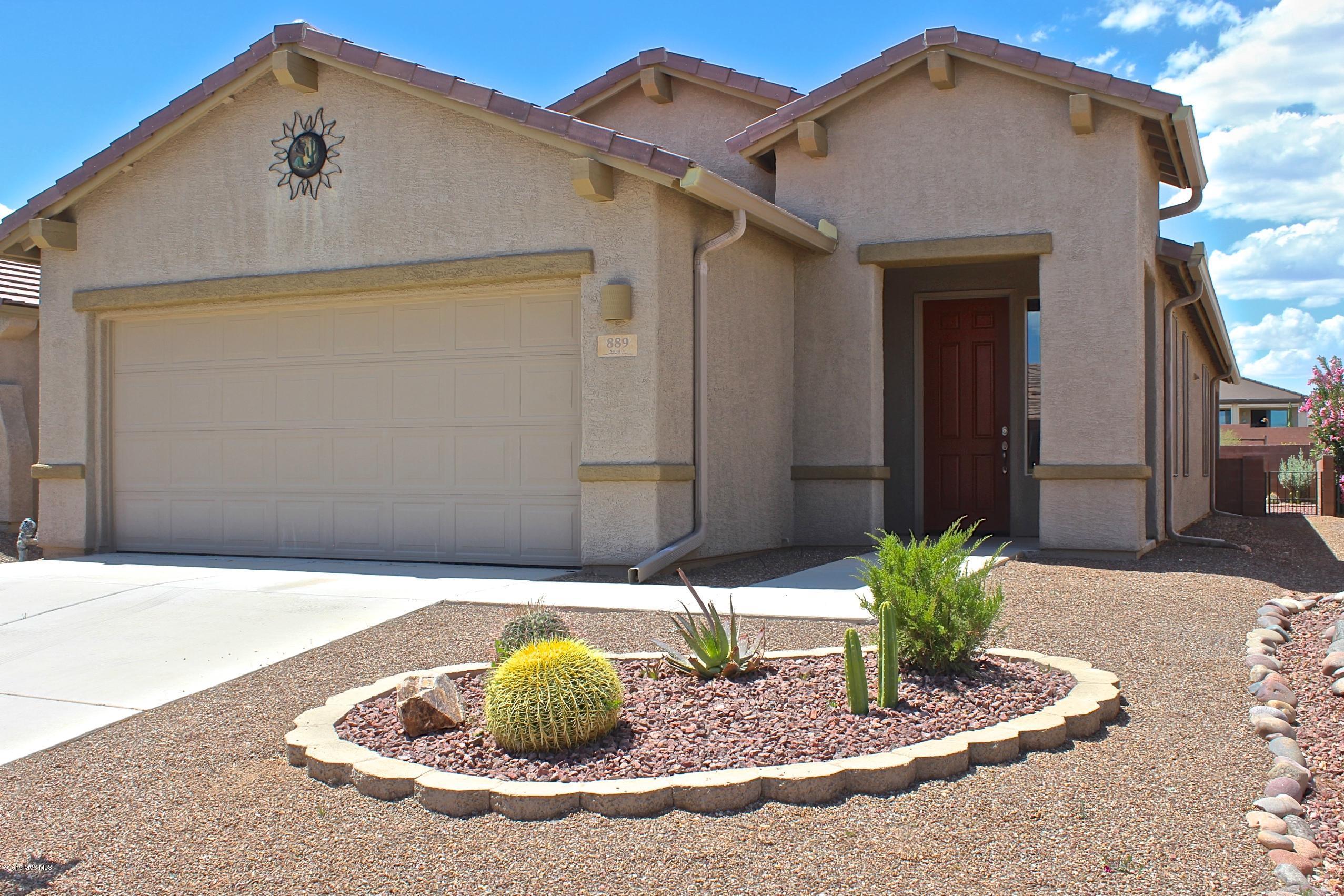 Let this home become your inspired living space! Charming front yard has beautiful desert curb appeal. As you come in you will love the complementary color hues selected throughout that create that high impact look you are seeking. Discover more than meets the eye with upgrades that matter most like travertine flooring through out, new garbage disposal & solar sun screens on all windows for a cooler summer house. Many added benefits include the extra R-38 insulation to help with utility bills, extra recessed canned lighting to brighten up the home, 4 C-Fans to circulate air flow, rain gutters to channel the monsoon rains away from the house, irrigation drip system to all plants, & pavers that lead to a BBQ area in the lovely private back yard which backs up to a common area. Exquisite!