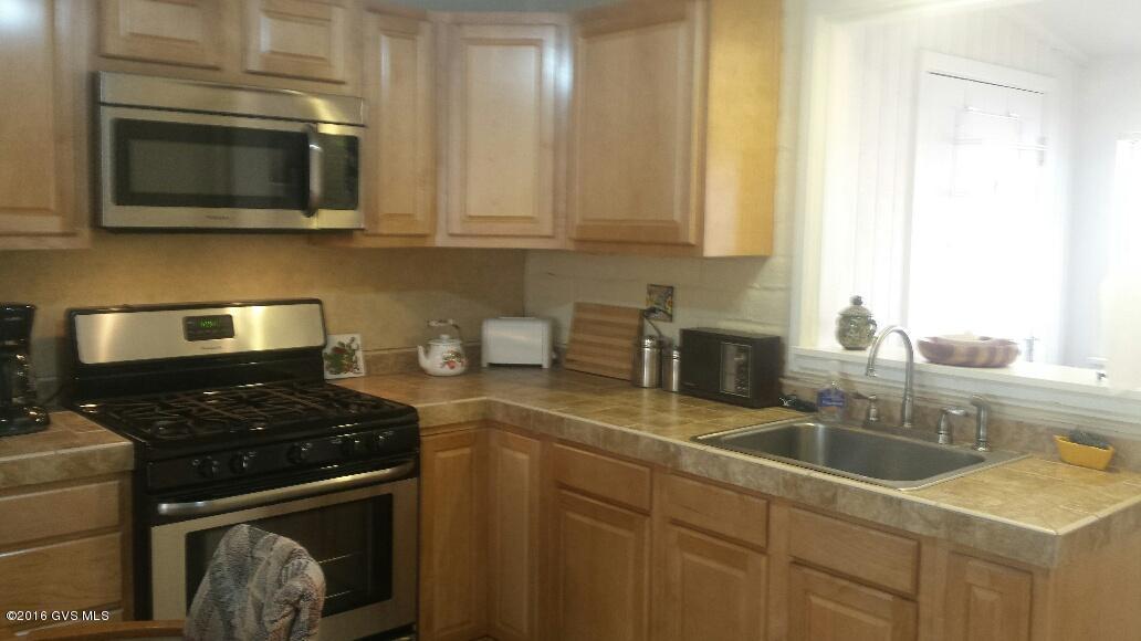 UPGRADED VILLA READY TO MOVE IN. YOU WILL LOVE THE NEW KITCHEN WHICH HAS OVERSIZED STAINLESS GAS STOVE WITH GRILL IN CENTER. MADE FOR THAT GOURMET COOK. ALL TILE THROUGH OUT. NEW VANITY WITH DRESSING AREA IN BATH. ARIZONA ROOM WITH BUILT IN DESK. WASHER DRYER. CONVENIENTLY LOCATED WITH PARKING OUT FRONT. NO G.V.R. BUT AVAILABLE. BRING TOOTHBRUSH AND MOVE RIGHT IN THIS FURNISHED VILLA. HOA COVERS WATER, TRASH, ROOF,HOT WATER HEATER, HEATING AND AIR CONDITIONER 2 POOLS, COMMON GROUNDS AND STREET MAINTENANCE