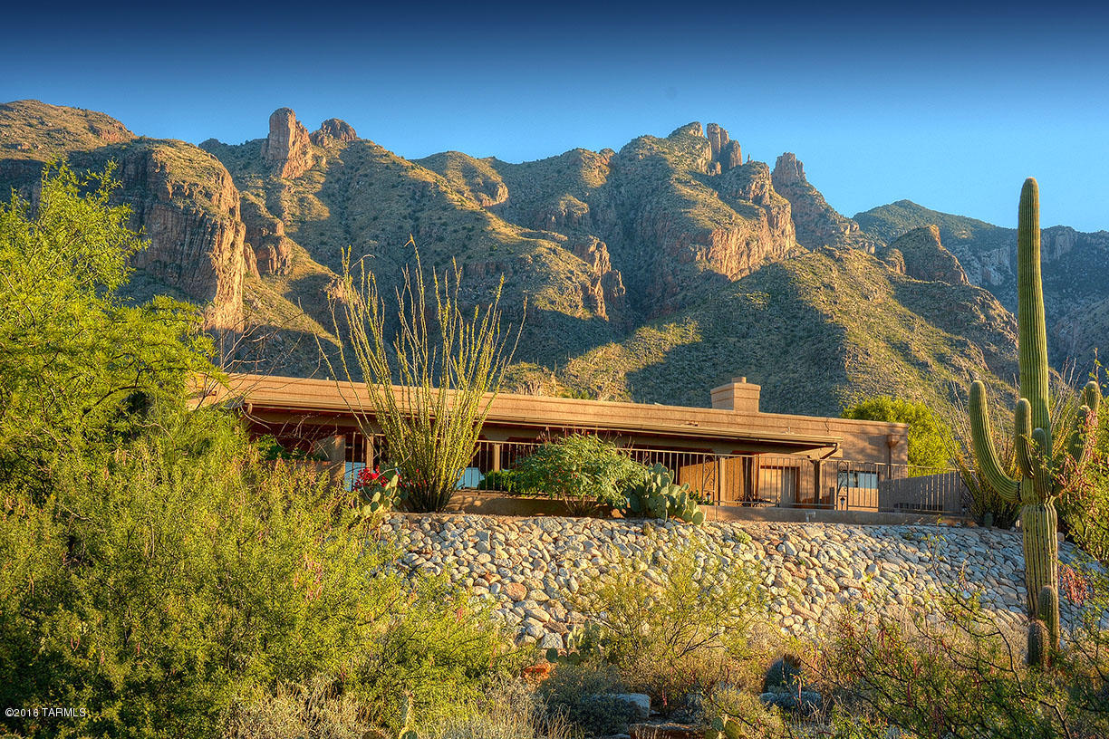 It's all about the views! Imagine both expansive city views and breathtaking mountain views all from your personal retreat high in the Foothills. Exceedingly private location features a long, winding driveway taking you to a lovely home with a full guest house. Every room boasts exceptional views. Gaze out onto the city from your bright  kitchen, or savor the mountain views from the living room or master bedroom.  Guest house is perfect for multi-generational living, featuring full kitchen, generous living room & bedroom, and separate garage.  See floor plan under Virtual Tour tab. With some updates there's a real opportunity to turn this into a million dollar home.