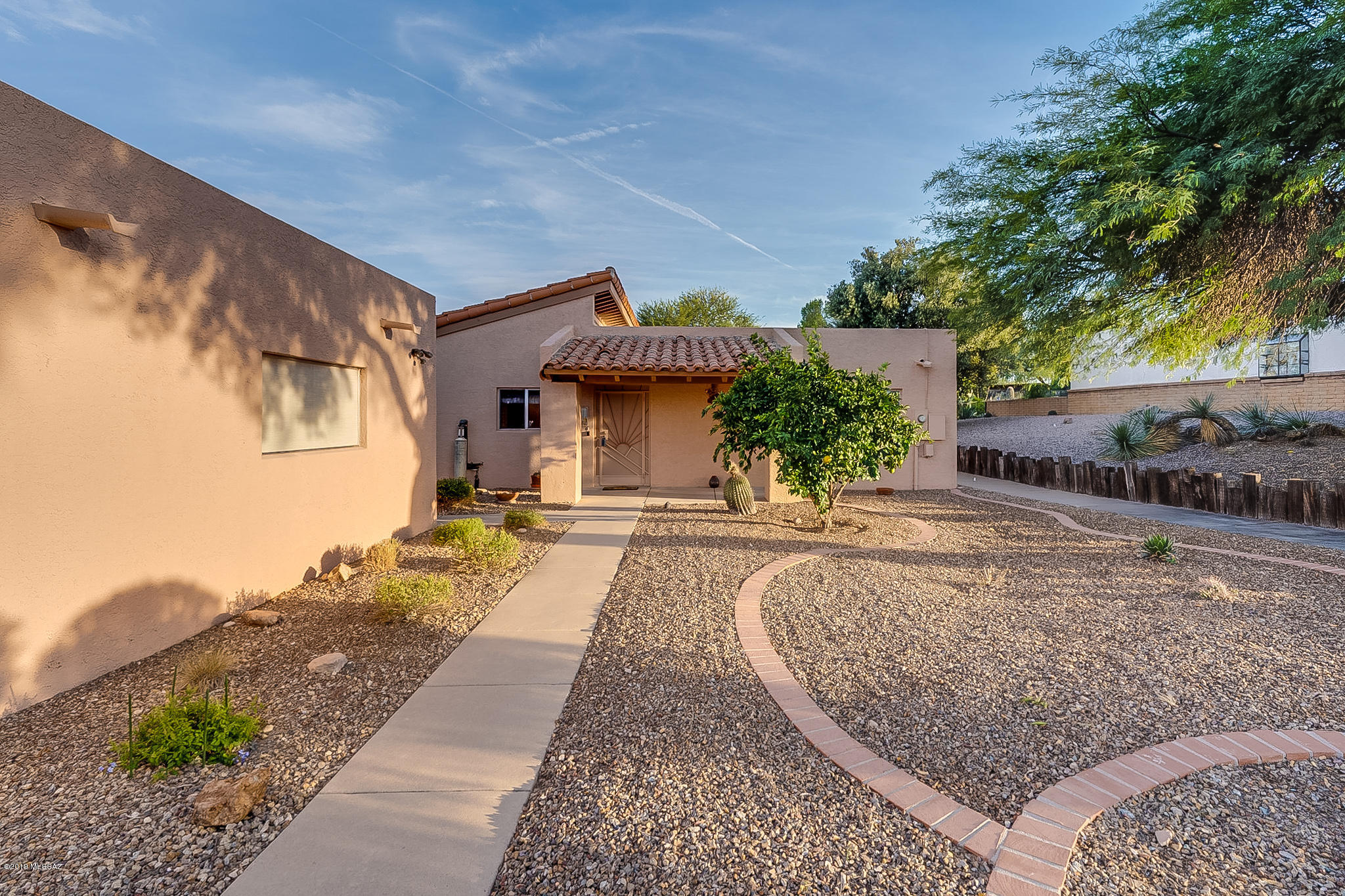 Looking for a Desert Oasis? This lovely 2bed/2bath townhome located in Desert Hills I is it! Enjoy over 1700 sq ft of living space, a detached 2-car garage, a private office/den, beehive fireplace, tons of natural light, enclosed Arizona room, a formal dining area, and a convenient eat-in breakfast nook. For your outdoor entertainment, enjoy the shaded patio that's just off the kitchen or the paved back patio that is steps from the beautiful Arid Garden! You will enjoy this comfortable and spacious home and the privacy that it offers. Come home for the winter or stay all year long!