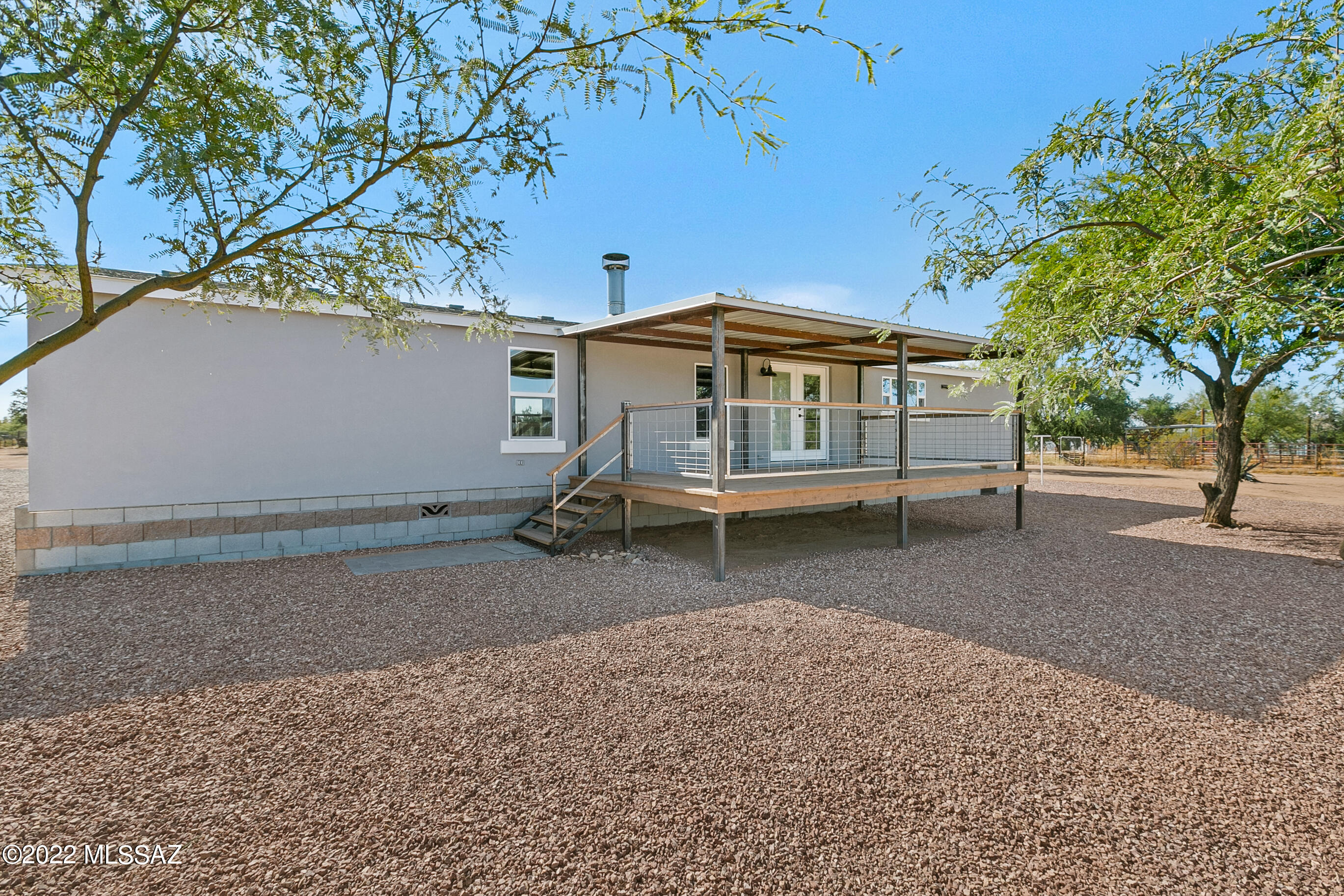 RANGE PRICE $360,000 - $380,000 Seller will counter or accept offers in that range. Meticulously remodeled home on 2, fenced in acres, provides freedom to live! BRAND NEW AC, ROOF 30 year shingles, Kitchen cabs, w/ quartz counter tops, dual pane windows, flooring, paint, cabs, fixtures, w/ a synthetic stucco finish on the exterior. Primary suite is equipped w/ his + her closets, dual sinks, vanity, and built in cabinet. Subway tile shower surround w/ dual shower heads. Gourmet kitchen has a farm sink, breakfast bar, natural gas range, floating shelves, and island w/ custom wood top. TWO steel metal frame decks w/ metal roofs provide PERFECT setting for enjoying the outdoors in shade. These decks are expansive with space for entertaining or cooking or whatever you want Gated entry w/ long gravel drive surrounded by clean open desert. Property has TWO Trico power meters + RV clean outs - just add another unit!! Don't miss out!