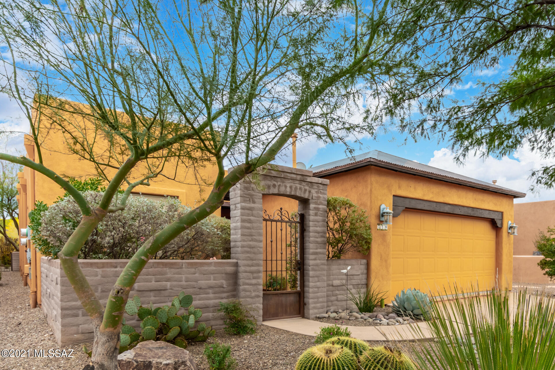 Fall in love with the beauty of this home and its setting in the desirable community of Barrio de Tubac. Gated entrance leads to a beautifully landscaped courtyard with pergola-covered double entry door and plenty of room for outdoor seating. Inside, you'll find an elegant space featuring custom woodwork, tilework, fireplace and updated fixtures and finishes. At the rear of the home, you're treated to panoramic mountain views through the living room's double-width sliders. These lead to a walled terrace offering plenty of room for elegant outdoor entertaining with add'l direct access from the home's bedrooms. Kitchen features Shaker-style cabinetry, butcher block island, stainless steel appliances. Owner's suite features walk-in closet and en suite bath w/ water closet, double-sink vanity.