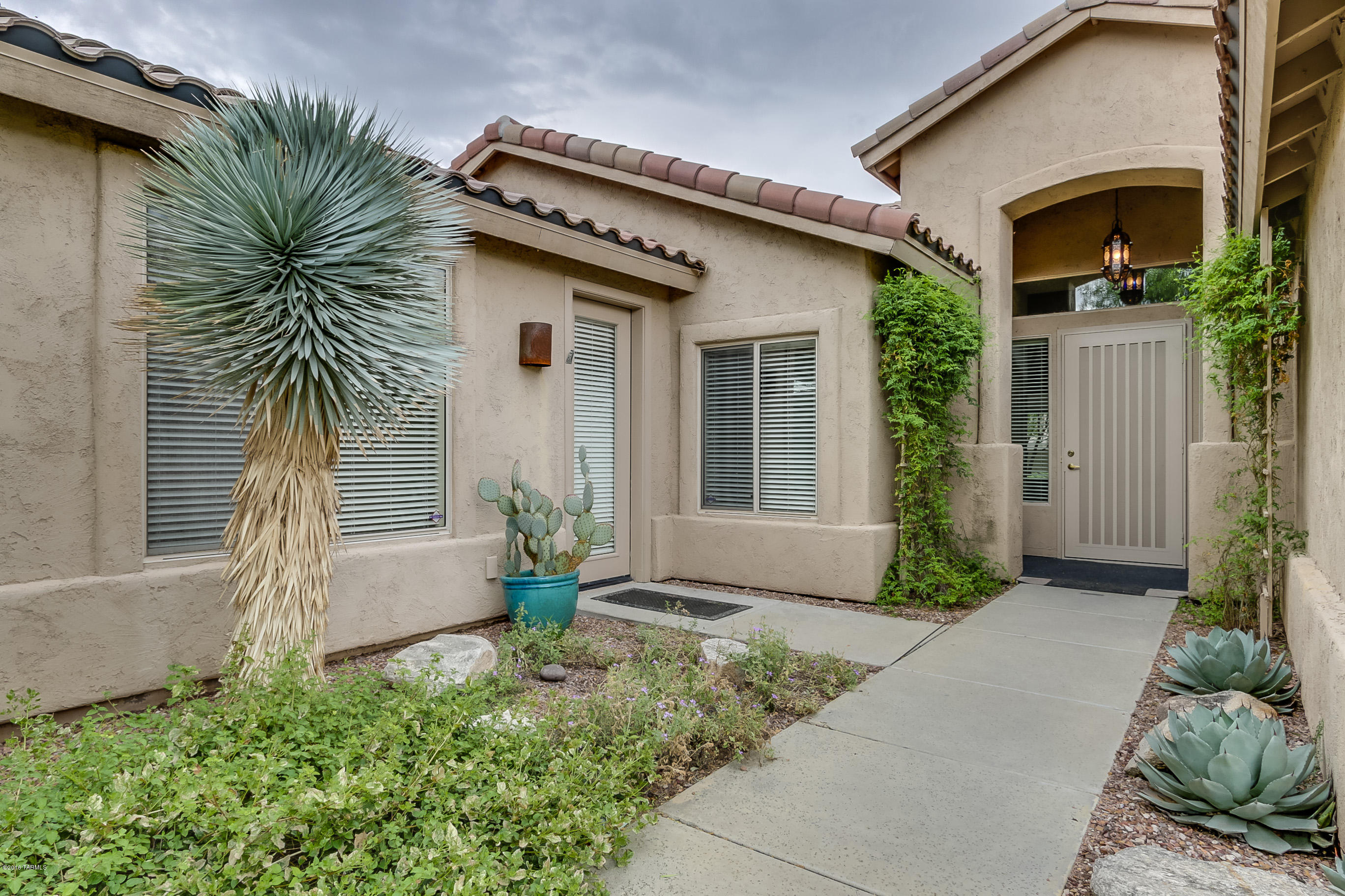 LOVELY FORMER MODEL on PRIVATE CORNER LOT in GLORIOUS GATED COMMUNITY.  ALL on 1 STORY.  FLEXIBLE split bedroom FLOOR PLAN boasts 2nd MASTER with PRIVATE entrance ideal as GUEST QUARTERS, & DEN easily convertible to 4th BR.  INVITING ENTRY, VAULTED CEILINGS, HUGE WINDOWS.  Enjoy EXPANSIVE FLAGSTONE PORCH & PATIO & LUSH FRUIT TREES from LIVING/DINING & OPEN GREAT ROOM & SPACIOUS MASTER SUITE.  The BEST COMMUNITY AMENITIES: FISHING LAKES, 2 POOLS (one heated), SPA, SAUNA, TENNIS, BASKETBALL, FITNESS, PLAYGROUND, all IMMACULATELY MAINTAINED.