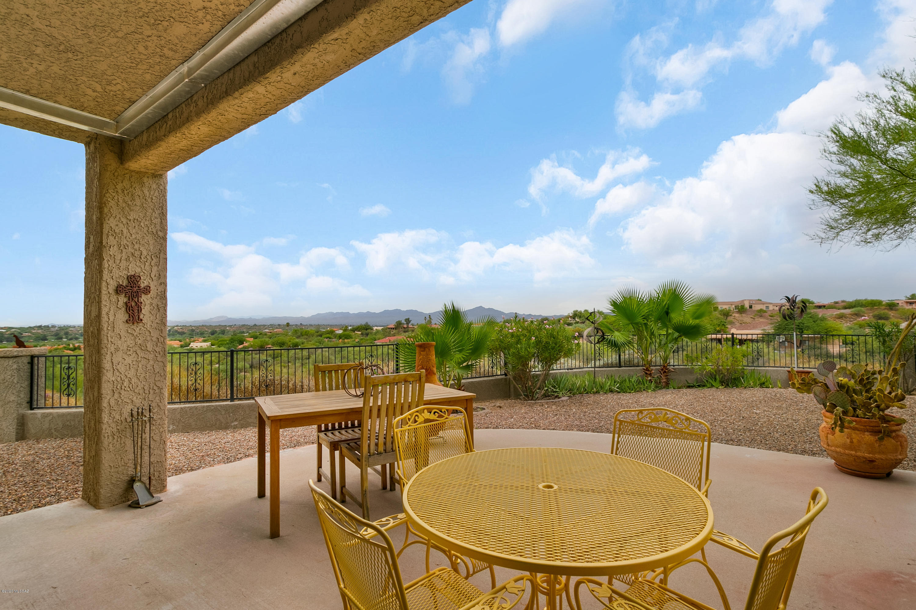 Contemporary Oro Valley Custom Home tops private ridge with dramatic 270 degree views. Just under 2 acres, serene peaceful location close to parks, recreation, schools, and everything! Lovely patios, gardens, citrus, pomegranate, tangelo, and almond trees. Designer kitchen features custom maple cabinets, granite counter tops, breakfast nook & work island. Large formal dining room open to living room with wooden decked cathedral ceiling. Bright & cheerful home presents skylights, tile flooring, and newly remodeled bathrooms. Energy efficient windows, rolling shutters, insulated blinds, and solar panels.  North-South exposure, vistas of Pusch Ridge, city, and Tucson Mtns. Livable/useable grounds with large backyard and hot tub to enjoy spectacular views!