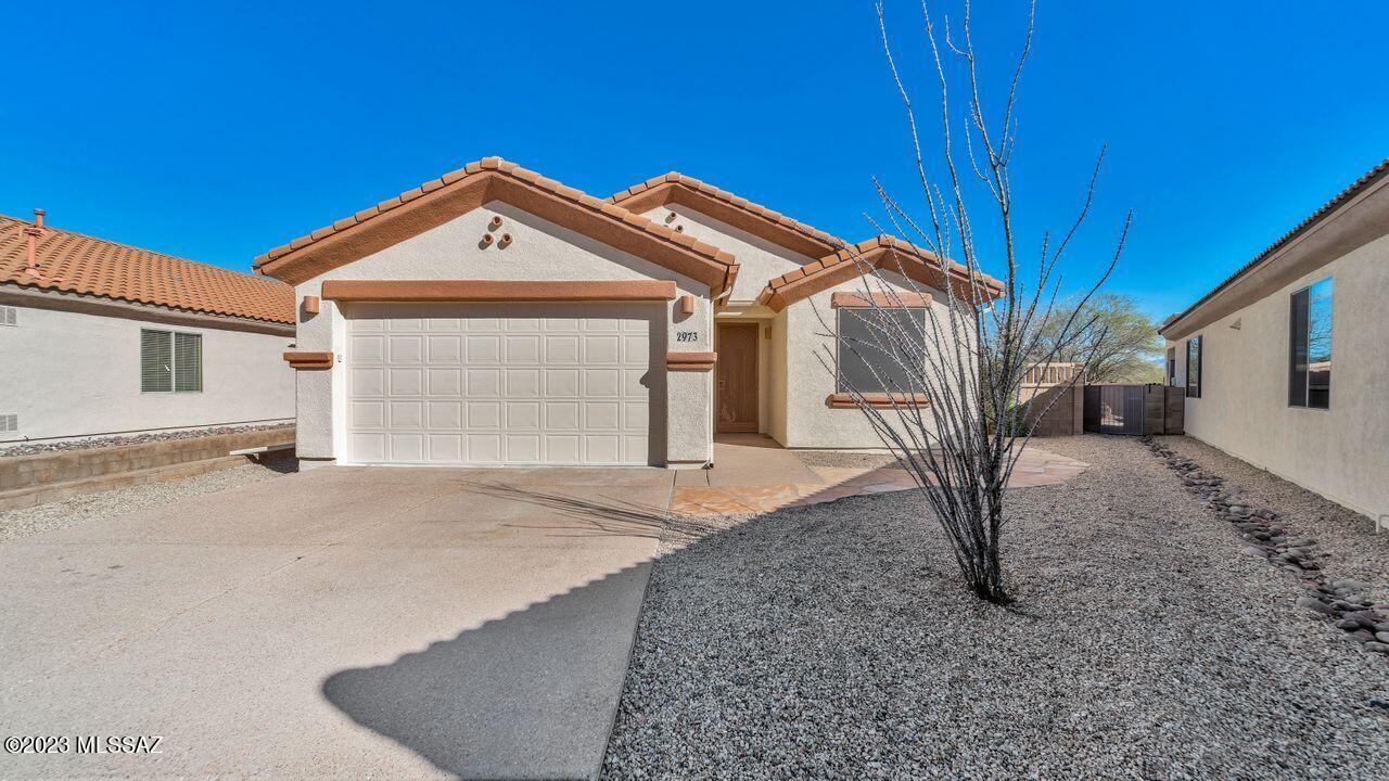 Enjoy Life in this 1744 sf single family home with 3 BR/2BA/2GAR.  Open concept Great Room has high ceilings and a Beehive Fireplace (gas) as a focal point . Spacious back yard has privacy, large wrap-around patio and concrete seating area plus a fountain (conveys as-is) and lovely Santa Rita Mountain Views.  Home has been freshly painted inside and out; and all carpet has been replaced.  Primary Bedroom has ensuite Bath with raised double vanities, walk-in closet and separate Linen closet.  Bedroom #3 could make a great office or Den.   2-Car extended Garage has utility sink and a soft water system.  Lot is 9,278 sq ft and backs up to Torres Blancas Golf Course.  This Location is easy access to shopping in GV, Golf, and to I-19 for points beyond.