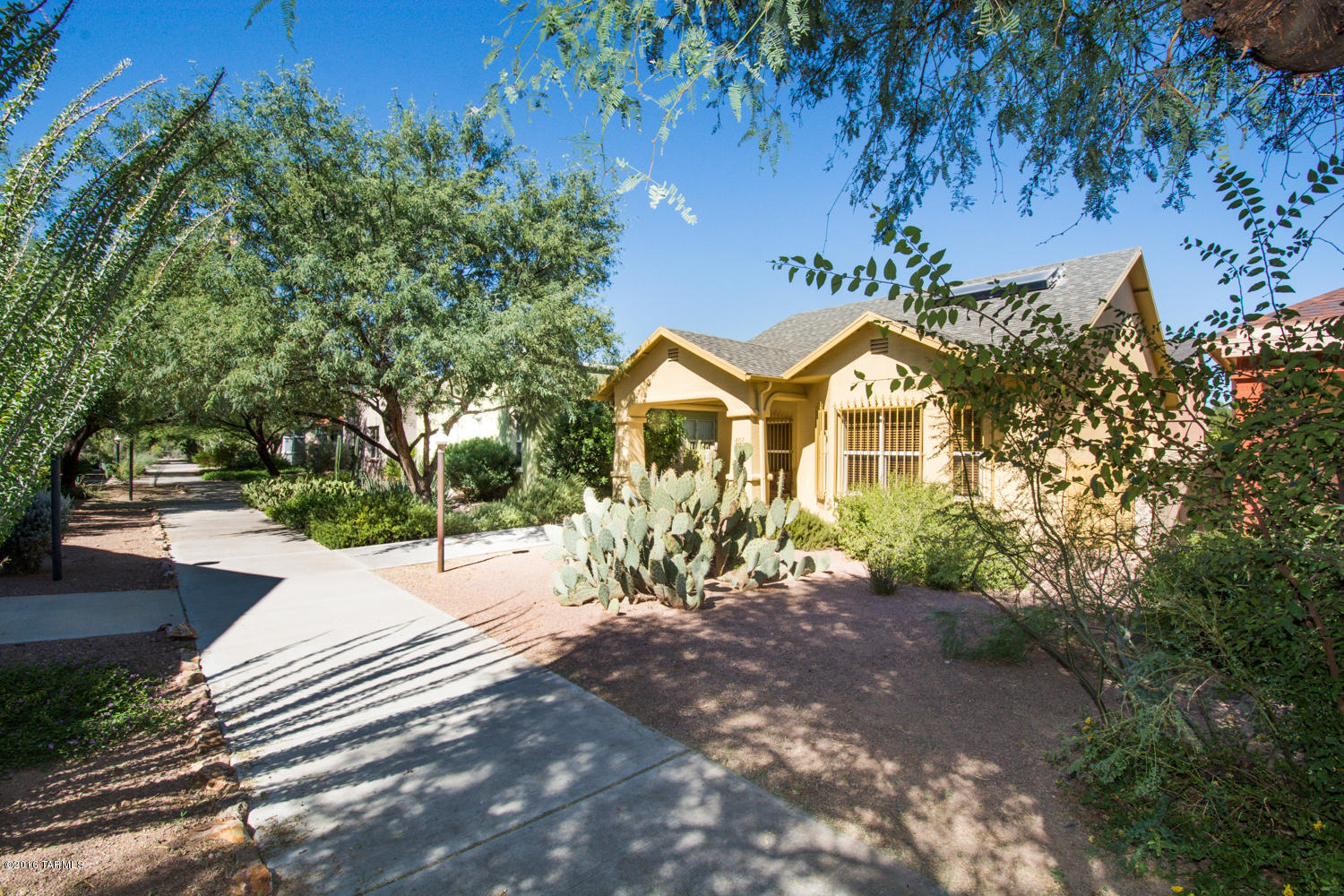 Modern Solar Bungalow! Charming location in Award winning Armory Park del Sol! Live downtown, surrounded by style, comfort and innovation! Enchanting neighborhood walkway leads to your front door; HOA maintained and softly lit at night! Solid masonry construction. Step-free entry, 3ft door openings and wide hallway-efficient, universally accessible design. Beautiful Wood & Tile Flooring. Colorful kitchen, w/side door to back yard. DBL French doors from MSTR BRM open to private wrought iron screened patio! Vacuum system, alarm, plus modern Solar systems. Two-car oversized garage. Enjoy a smart Downtown lifestyle near beautiful Victorian Homes! Just 4 blocks to the new streetcar line. EZ-access to U of A and all amenities of Tucson's Downtown business district.
