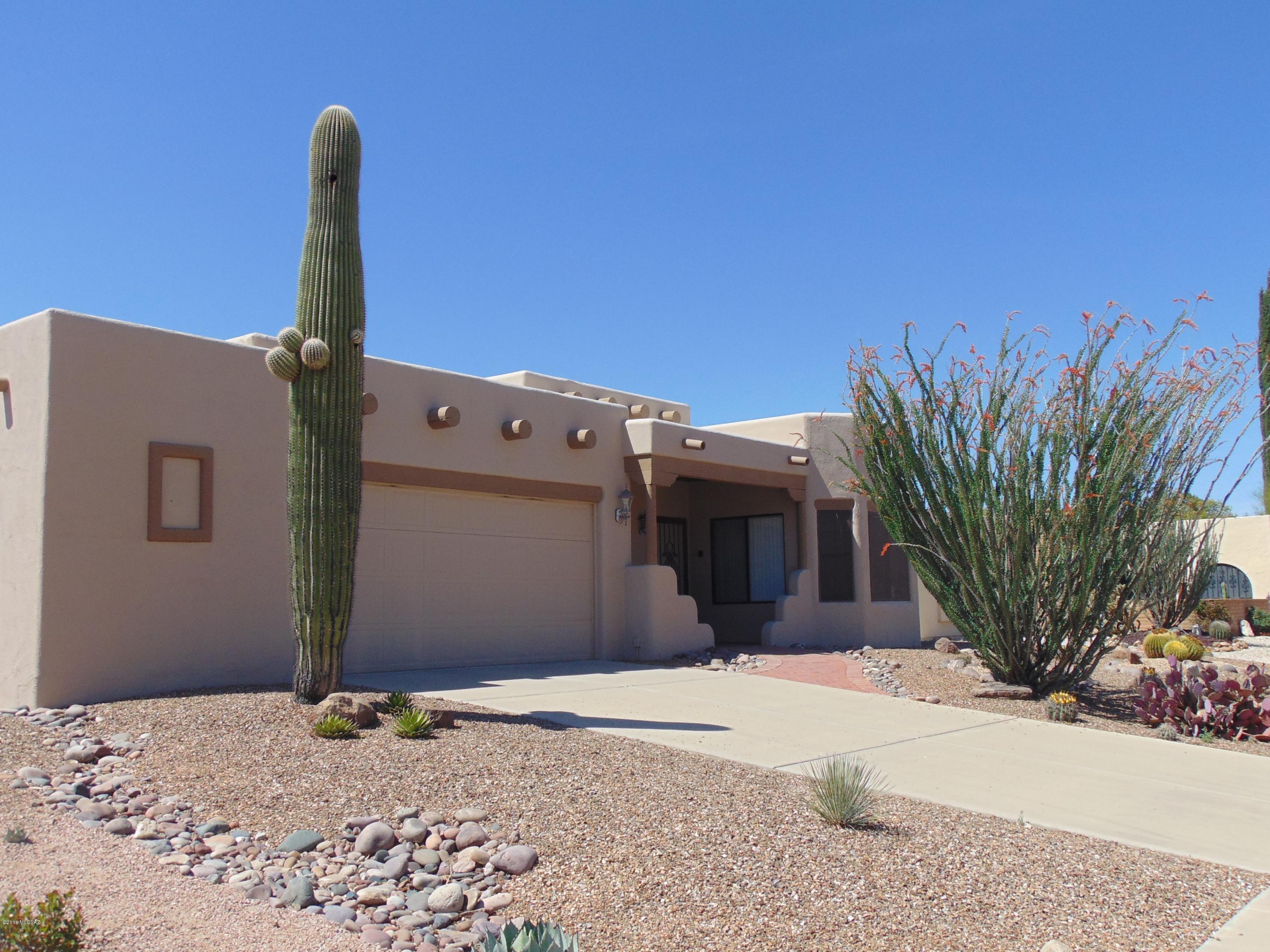 Looking for a Custom Built  Santa Fe Style home with Character? You found it!  This 1422 sqft/ 2BD/2BA + Den and 2 Car Garage has a lot to offer.  Enter the house to the Living/Dining area with Tile flooring, Ceiling with Charming Wood Vigas, Tile Gas Fireplace. Good size Kitchen with Island, Tile Counters, Breakfast Nook with Bay Window and Stainless Steel Appliances. Master Bath Offers Southwest Style Tile Counter and Shower. Walk in Closet. Guest Bedroom with Convenient Murphy Bed. Den with Small Closet, Tile Flooring and Bay Window. Laundry Room with Extra Storage Closet. 2 Car Garage has Extra Space for Work Bench or Storage. Take Advantage of Country Club Estates low HOA. Property has Green Valley Recreation Membership .