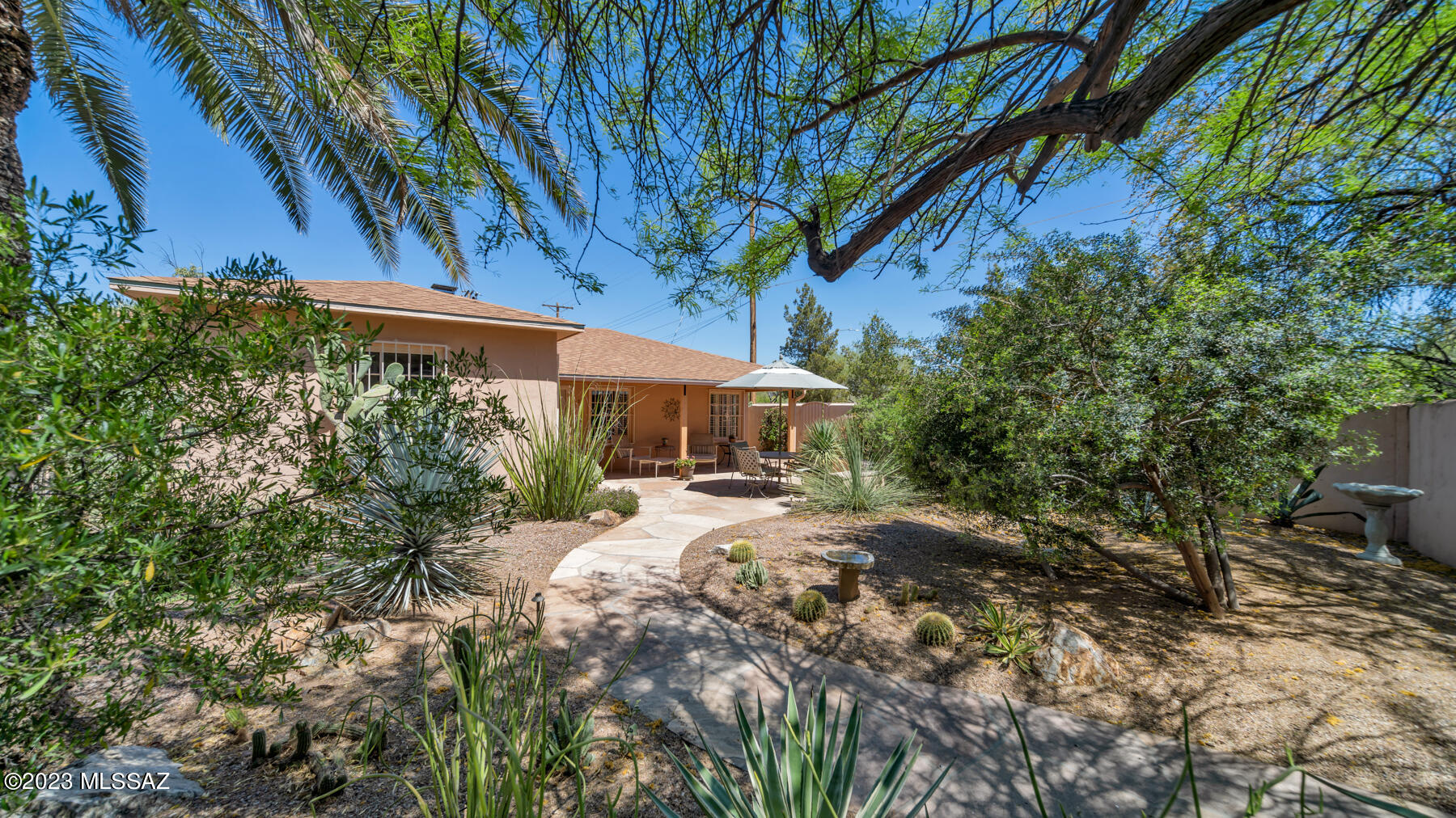 Gated courtyard entry to Private bungalow residence and guest studio. 2BR/1BA main home + Detached 1BR/1BA guest studio. Flagstone patios and walkways capture a distinctive charm of Tucson! Quiet patios, mountain vistas and the warmth of an outdoor patio fireplace! Rear gate, by Fireplace, opens to a garden patio, adjoining guest studio. and rear carport. Remodeling projects in the last 10 yrs, preserved the unique charm of the property. 9Ft+ ceiling height, with abundance of doors and windows bring natural light to rooms! Custom ''California Closets'' designed in home + studio add a modern touch of efficiency! Main home and guest studio new roofs 2016 Laundry Room entry from private ''clothes line'' patio on the West side of residence.  The charm of this 1937 era property is magical