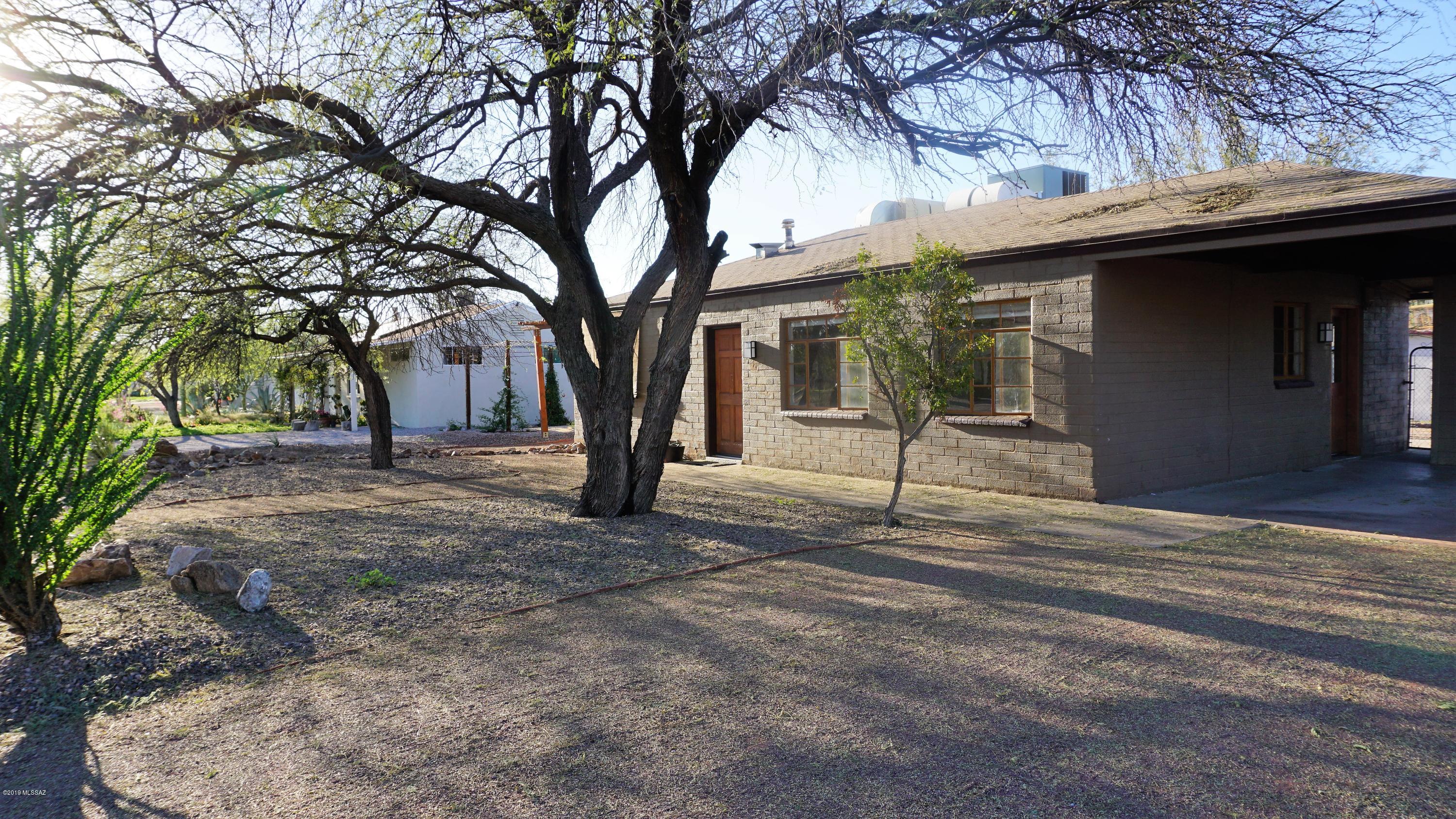 Seller will Accept or Counter Offers $160,000-$165,000. Charming Central Home! Picturesque Yard with artistic touches. Mature Mesquite Trees, undulating pathways, Pergola, Rock Garden in Front, Cacti Garden in Backyard. Drive through double gate to Backyard. Lengthy Covered Patio,  Planting Beds, Garden Composter, Extra Storage Shed. Covered Parking with additional uncovered space and attached 2nd Storage Shed. Sweet Retro Bathroom with the perfect Hardware, Lighting, & Original Niche. Kitchen has been updated with Maple Cabinetry including Pantry, & all the comforts of a newer home including Dishwasher, Garbage Disposal, Built In Microwave, Gas Range, Stackable W/D! Contemporary Ceiling Fans throughout & Dual Cooling helps keep utilities reasonable. Close to everything. Location, location