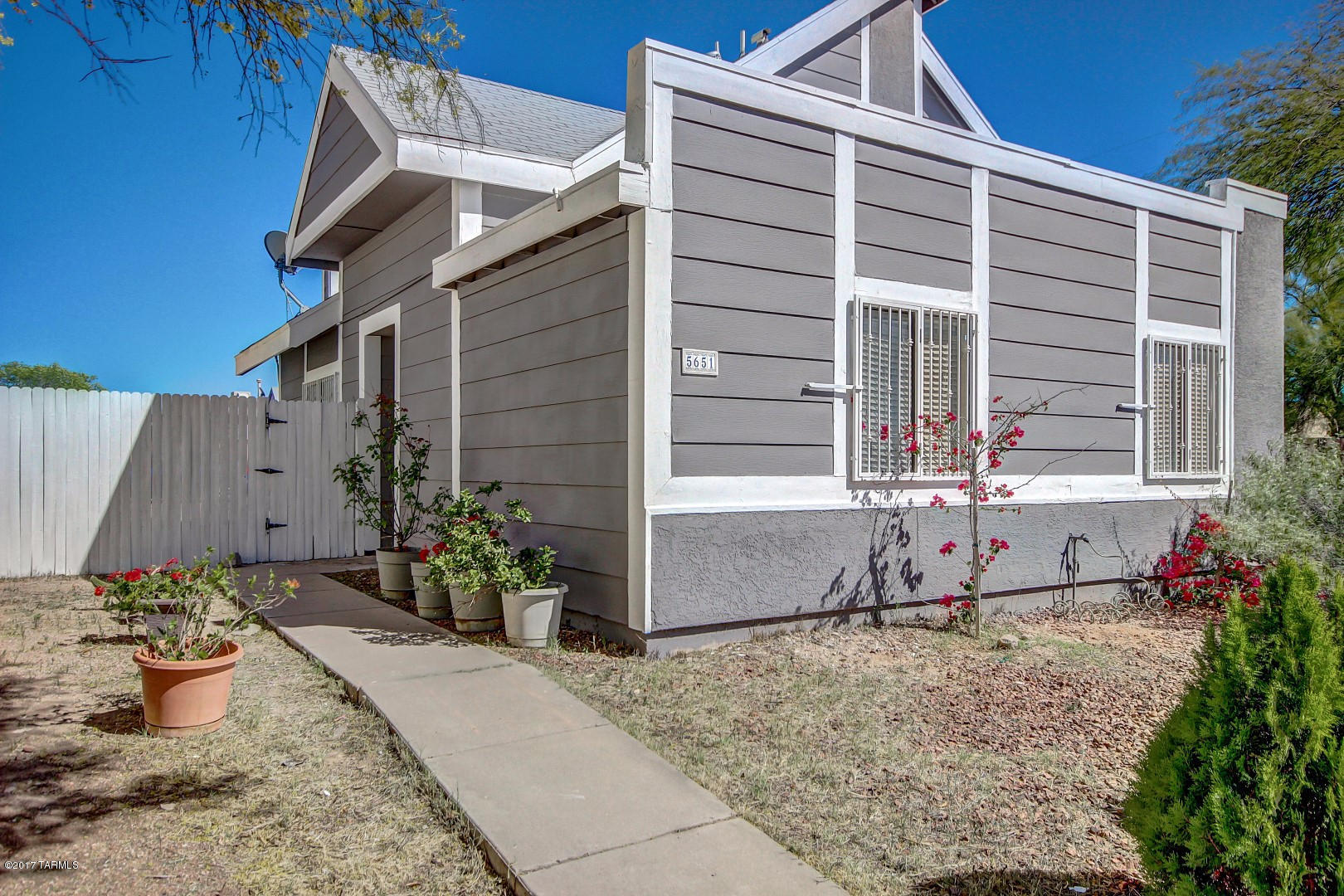 OPEN HOUSE 4/1/17 from 2-5pm and 4/2/17 from 4 to 6pm. Outstanding Contemporary Home with soaring ceilings, warm palette, beautiful tile floor, window blinds, upgraded lighting, cozy fireplace, and floating stairway to second level. Fantastic eat-in kitchen features stylish counters, white appliances, and stunning hickory cabinets. Patio access from dining area. Plush carpet in all bedrooms with private balcony, and vaulted ceiling in master bedroom.  Enjoy the backyard covered patio with plenty of room for your future desert oasis. Will NOT disappoint.