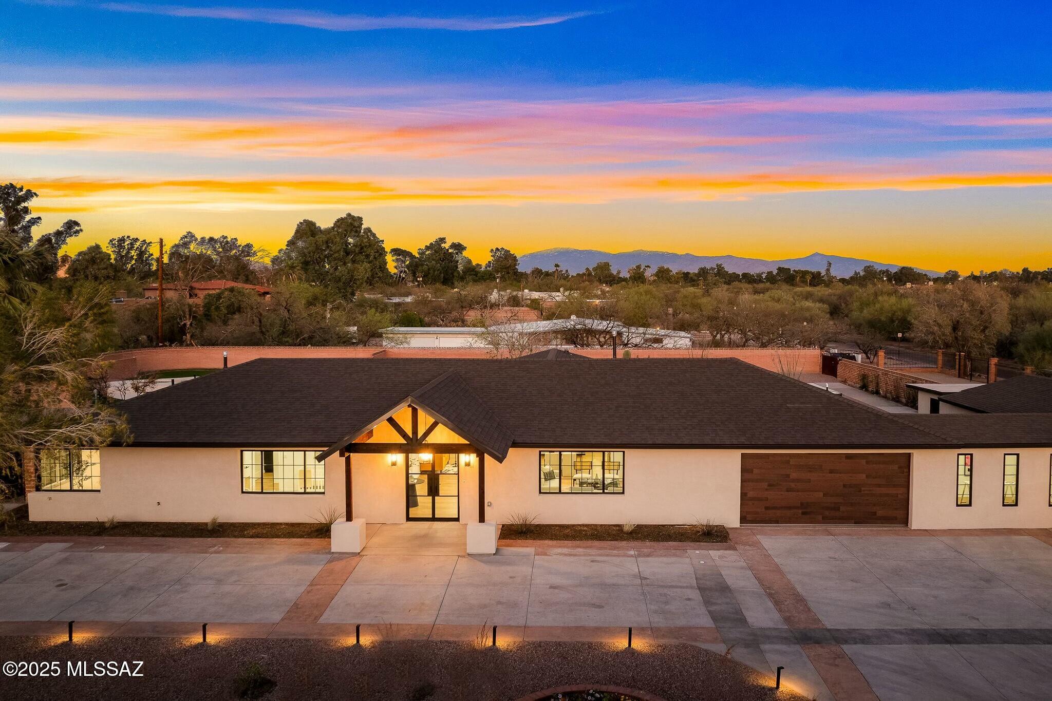 Set on nearly an acre in one of Tucson's most desirable enclaves, this fully remodeled and expanded residence now offers over 4,200 sq ft of light-filled living space. No detail was overlooked in the 2025 transformation — from new HVAC, plumbing, and electrical to custom steel doors, quartz countertops, and designer finishes throughout. The main home showcases an impressive great room with soaring ceilings, a chef's kitchen with professional-grade appliances, and seamless indoor/outdoor flow for entertaining. A thoughtfully designed floor plan provides four spacious bedrooms and four spa-inspired baths, including a luxurious primary suite retreat.
A rare 1,300+ sq ft guest house offers ultimate flexibility — perfect for multi-generational living, private office/studio or income potential. The expansive grounds feature mature landscaping and multiple patios for enjoying Tucson's sunsets. Priced below recent appraisal for immediate opportunity  new-construction quality in a premier historic neighborhood, minutes to University & downtown. Recently appraised at $1,700,000  that's $200,000 above the current list price! Take advantage of this incredible opportunity to own instant equity in a truly exceptional home.