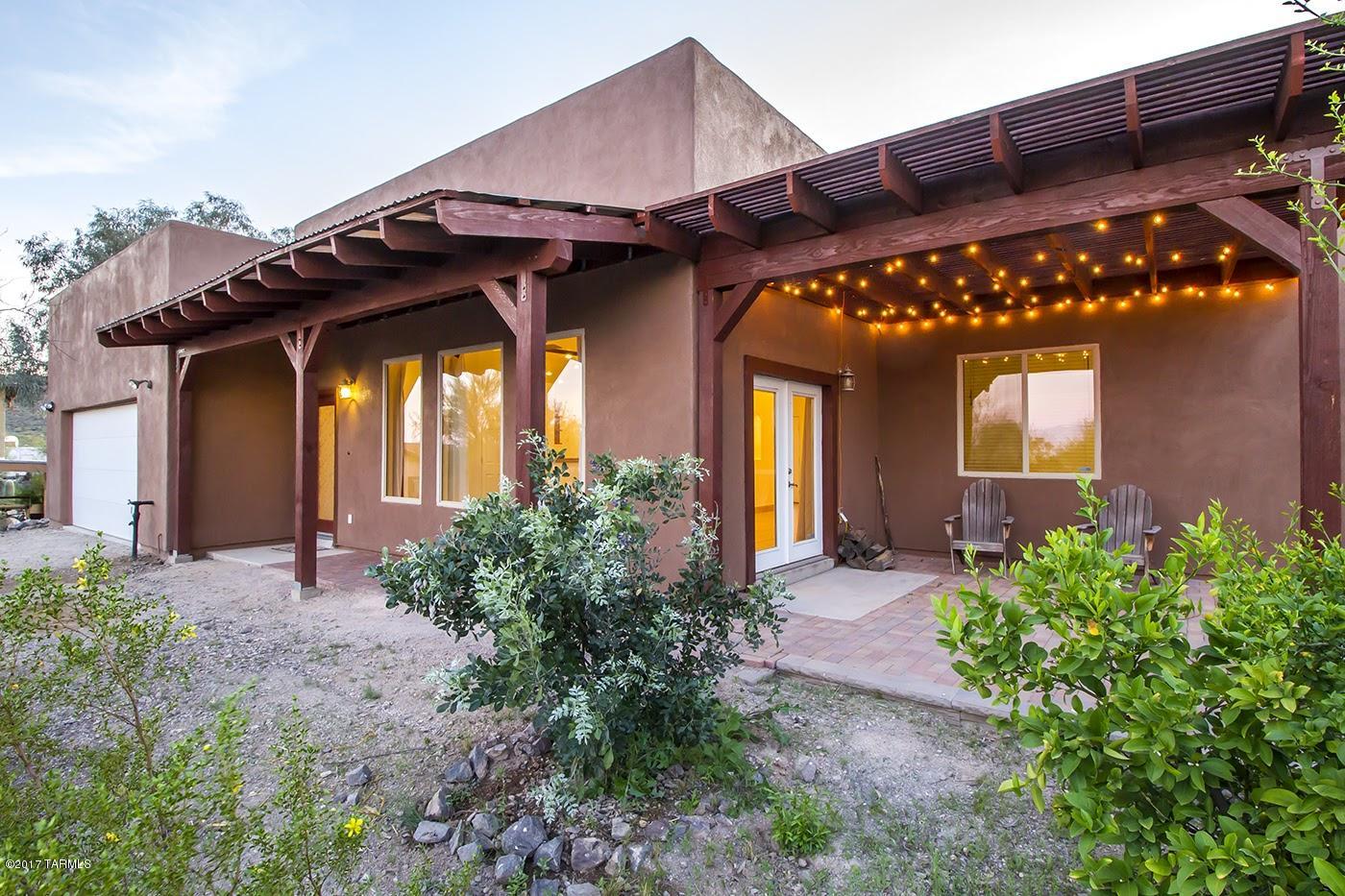 This custom, west-side home has the views and privacy of a premium property, for signifcantly less than it's Foothills counterparts.  Enjoy the unobstructed views of Tucson from the covered front patio, and the majestic Tucson Mountains from the back yard.  The interior has vaulted ceilings throughout, with an open kitchen and convenient family room.  The bedrooms are all large, and both bathrooms have been completely remodeled and upgraded.  This amazing home is just a ten minute drive from Downtown Tucson, and just two miles from the Starr Pass Marriott Resort.