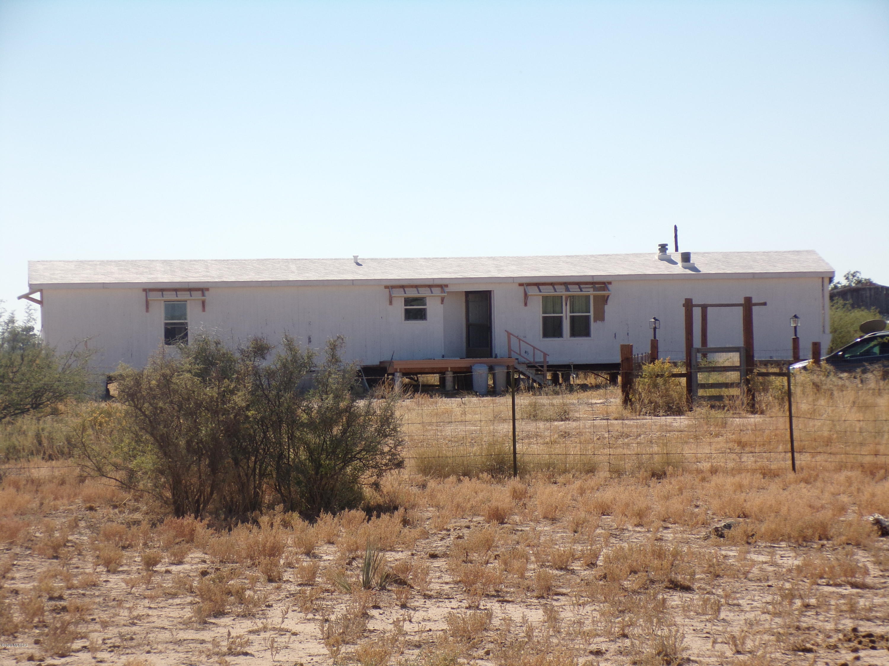 2 bedroom 2 bath home on 5 ac fully fenced and cross fenced.  with 5 separate pastures. Walk-in closets, New electric cook top being installed. Also In the process of putting new skirting around the home and awnings. Large Barn/workshop with cement floor, electric.  This is a great fixer upper. It has good bones but needs some TLC. Its in a great location. Make an appointment.