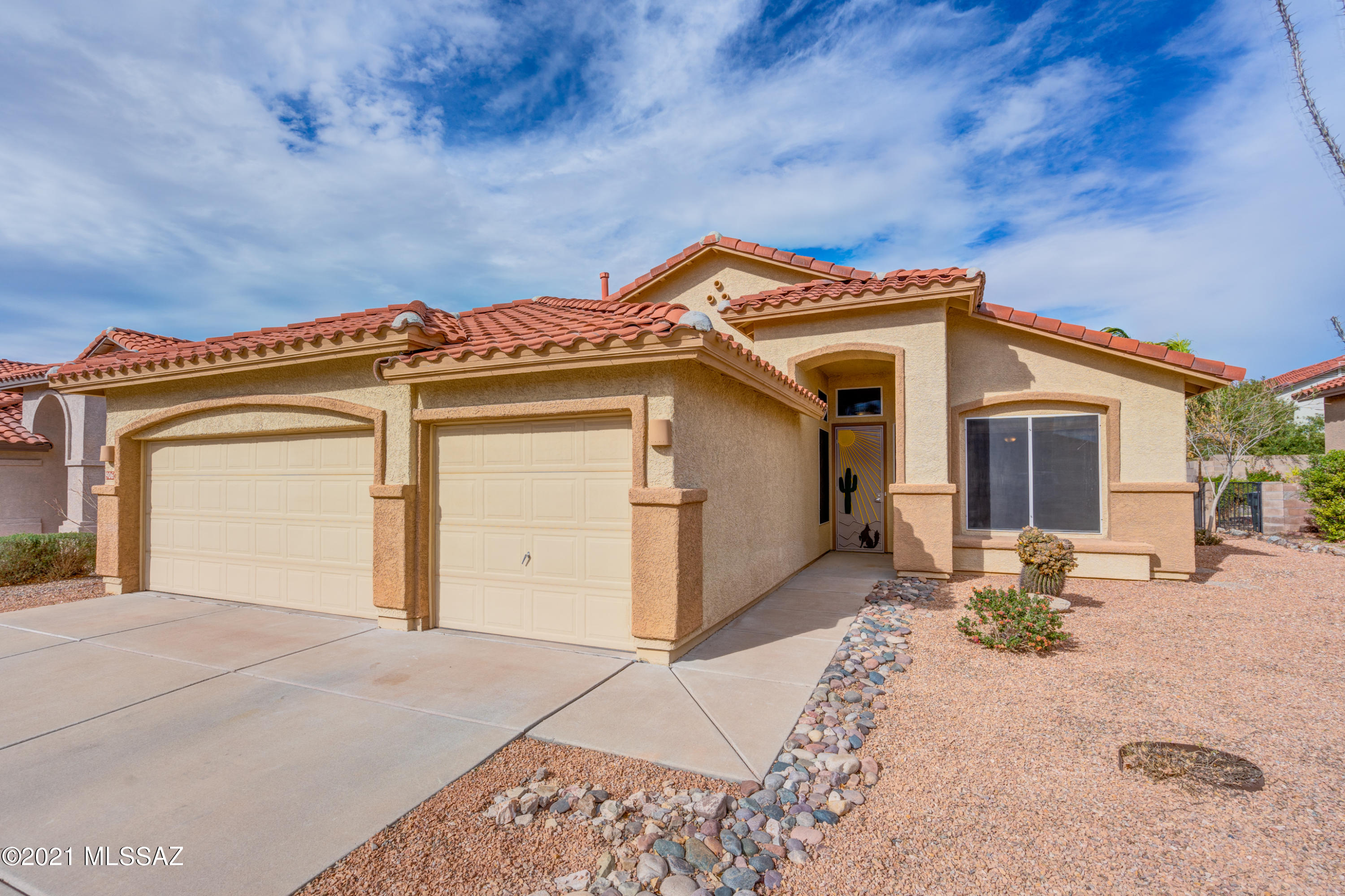 RITA RANCH BEAUTY! This 4 Bed/2 Bath home has been meticulously maintained! Curb appeal abounds with huge lot, 3 car-garage, and awesome backyard! Features include fresh interior paint, plank tile floors throughout, arched entries, ceiling fans, wooden blinds, pendant lighting, stainless steel appliances, granite counters, gas range, vaulted ceilings, integrated slider blinds, custom tile in primary shower, garden tub, dual vanities, walk-in closet, tons of storage, garage workbench & accessible attic space in garage! Maytag washer/dryer, termite warranty, newer HVAC, water softener, security system and custom front security door!  Covered patio with flagstone, shade screen, elevated seating areas, turf, kiva fireplace, storage & shed complete this amazing home! Close to everything Vail!