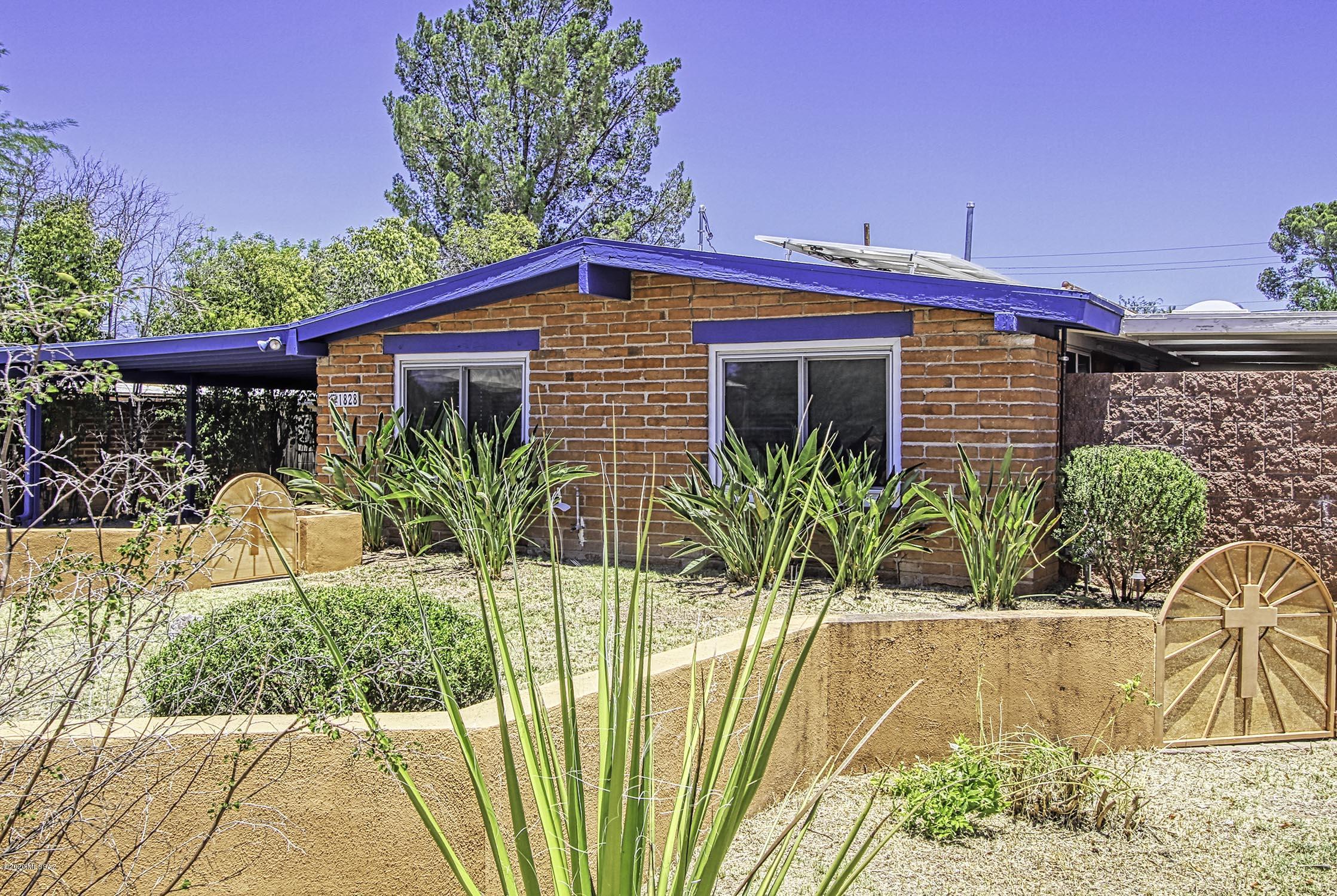 Price Range $240,000-$248,000. Updated burnt adobe in fantastic Central location! Spacious great room w/high ceilings, diagonally laid ceramic tile & sep dining area. Remodeled kitchen w/gorgeous cherry cabinetry, pull-out shelving, soft close drawers, granite countertops & SS appliances. Good-sized spare rooms & nice master w/oversized closet & newer bath w/walk-in shower w/cultured marble surround. Huge family rm/den w/wood burning fireplace, extra closet & private entrance could easily double as home office or game room. Lush landscape, lg ramada w/electric, gas bbq, extra storage shed & side covd patio too. Gated sparkling pool is handicap accessible w/ramp & rail. Addl 10x26 workshop w/220, oversized double carport & rain collector. Dual pane windows, 2019 hvac & owned solar. Don't m