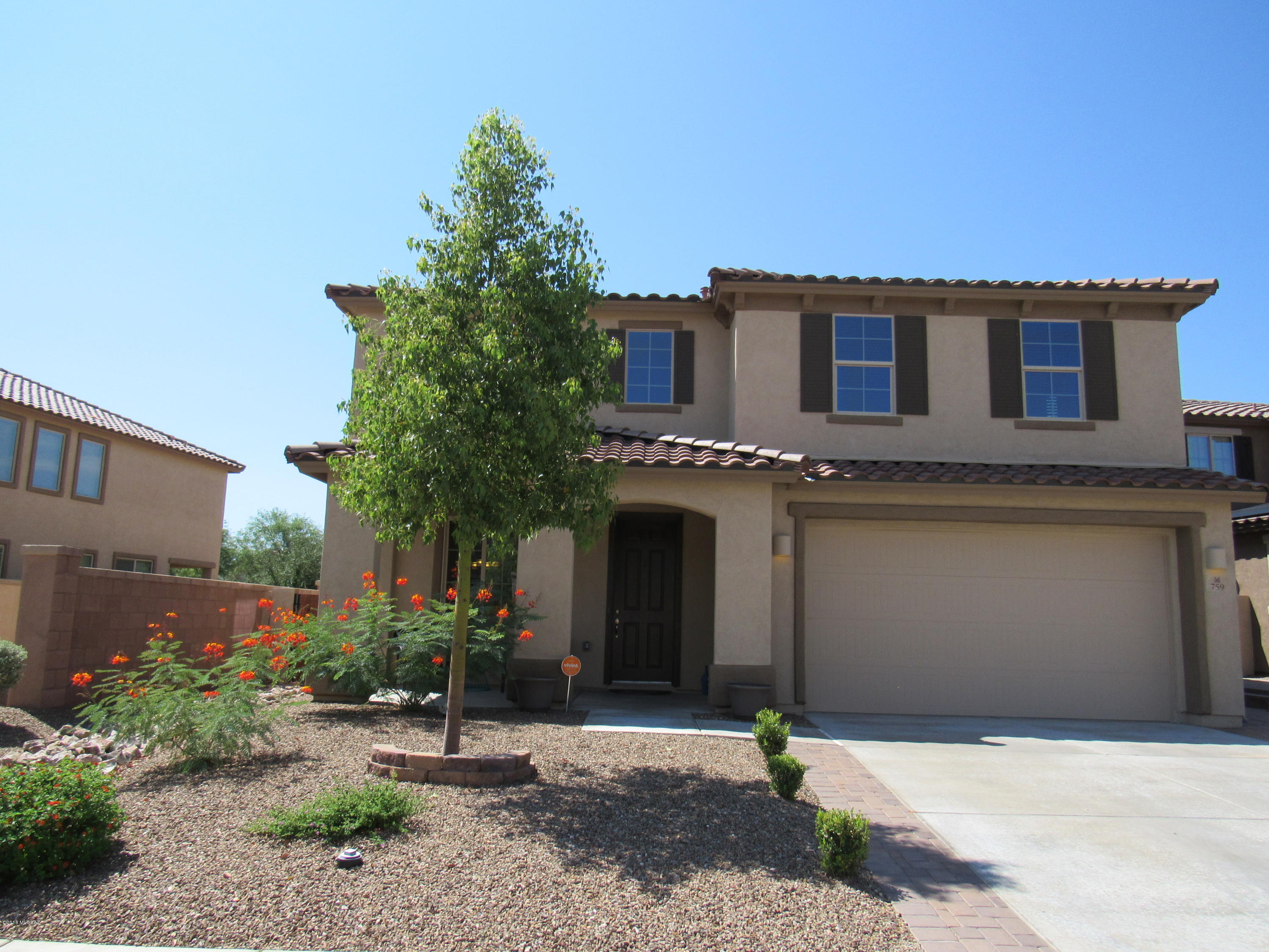 Here's an absolutely stunning 4 bedroom, 3 full bath home w/ over $60,000 in upgrades, professional landscaping, and high end finishes. Boasting an amazing gourmet kitchen, w/ granite counters, upgraded 42'' cabinets, a huge island w/ breakfast bar, walk-in pantry, farmhouse sink, double wall ovens and a gas cook top. The wood-look tile flooring, goes well w/ the neutral paint and custom accent walls. There's a bedroom and full bath downstairs, perfect for guests. The backyard oasis has a built in kitchen, a water fountain and pond, pavers, gas fire pit, and surround sound speakers. Located w/in walking distance to the north satellite pool and park. Situated on a premium lot, w/ no rear neighbors and bordering a wash, for added privacy. A beautifully finished home, in an awesome community!