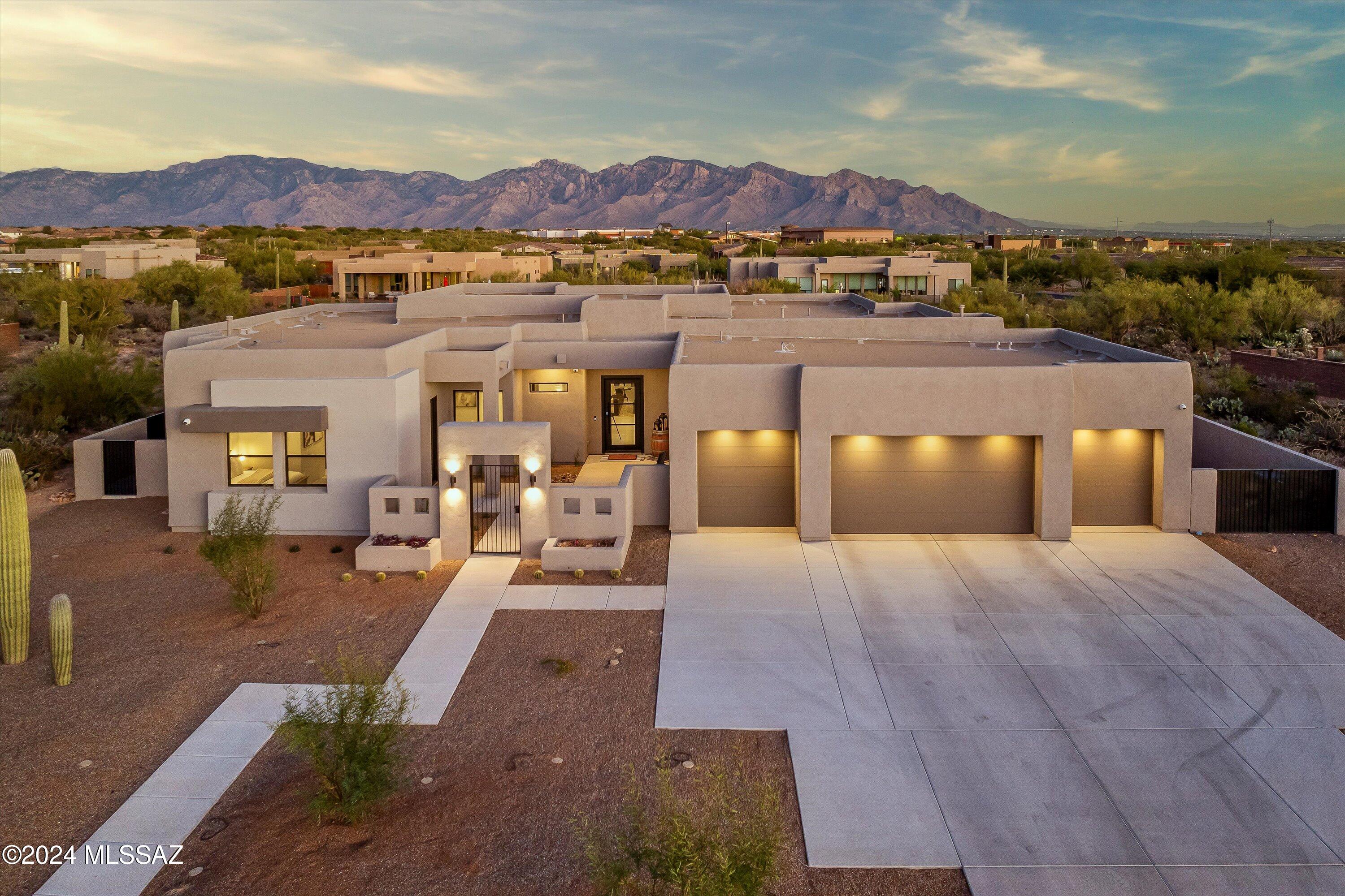 A masterpiece of modern living: blending luxury, technology, and unparalleled efficiency. Welcome to this meticulously designed, fully-upgraded home spanning nearly 3600 sq ft on the largest lot in the community, offering breathtaking Catalina Mountain views. Every detail of this residence has been curated with care, blending timeless elegance with innovative functionality.

State-of-the-art Interiors
Step inside and experience a seamless integration of luxury and technology. From hardwired, automated blinds operable by remote or mobile device to SureFit LED lighting with incredible longevity, this home redefines convenience. A custom bar, complete with a beverage center and wine fridge, creates a perfect centerpiece for entertaining.

The kitchen is a chef's dream, featuring waterfall quartz countertops, upgraded built-in JennAir appliances, a walk-in pantry and under-cabinet outlets for a clutter-free design. Enjoy medical-grade water with the reverse osmosis system, extending to both the kitchen sink and refrigerator.

Top-of-the-line Appliance Package
The premium JennAir® appliance package showcases how each unit is meticulously designed to enhance functionality and elevate the culinary experience.

RISE" 30" Combination Microwave Wall Oven: This appliance offers a 1.4 cubic foot microwave capacity and a 5.0 cubic foot oven capacity, providing ample space for various cooking needs. The V2" vertical dual-fan convection system ensures even heat distribution, resulting in consistent cooking results. The 7-inch full-color LCD display offers intuitive control, while the speed-cook function combines microwave and convection cooking for quick, efficient meal preparation. The Durafinish® protection keeps the stainless steel exterior looking pristine by resisting fingerprints and smudges.

PRO-STYLE® 48-inch Professional Wall-Mount Hood: This ventilation system features a 1,200 CFM high-performance blower, effectively removing smoke and odors from the kitchen. Radiant and ready: dishes stay primed under restaurant-inspired lamps. The dual lighting levels provide both task and ambient lighting, enhancing visibility and ambiance. The stainless steel baffle filters are dishwasher-safe, ensuring easy maintenance. The AutoSense function adjusts the fan speed based on heat levels, optimizing performance and energy efficiency.

RISE" 48-inch Built-in Side-by-Side Refrigerator: This refrigerator offers a total capacity of 29.5 cubic feet, with 19.2 cubic feet for fresh food and 10.3 cubic feet for frozen items. The TwinFresh" climate control system maintains independent climates in the refrigerator and freezer, preserving food freshness. The Obsidian interior adds a touch of elegance, while the exterior ice and water dispenser provides filtered water and ice at your fingertips. The multi-point cinematic lighting illuminates the interior, showcasing your ingredients beautifully.

Whisper-Quiet 15-inch Trash Compactor: This appliance offers a 5:1 compaction ratio, reducing trash volume significantly. The fully integrated controls provide a seamless appearance, and the anti-jam and tilt sensors ensure smooth operation. The Whisper Quiet® Plus sound insulation system minimizes operational noise, maintaining a peaceful kitchen environment.

RISE" 24-inch Built-in Dishwasher: Operating at a quiet 38 dBA, this dishwasher ensures a peaceful kitchen ambiance. The Trifecta" wash system delivers exceptional cleaning performance, while the Precision Dry® Plus option ensures dishes come out dry and ready to use. The removable third-level rack provides additional space for utensils and small items, enhancing flexibility. The stainless steel interior resists stains and retains heat, contributing to efficient drying.

This JennAir® appliance suite combines advanced technology with sophisticated design, setting a new standard in luxury home amenities.

Designer-level Floorplan
The open-concept layout showcases a wide-mantled fireplace with floor-to-ceiling tile, polished white concrete floors, and exquisite details such as a petrified wood sink and crystal light globe fixtures in the powder room.

Luxurious Living Spaces
The expansive primary suite features dual vanities, upgraded quartz countertops, concrete sinks, an over-sized walk-in closet and pass-through laundry access. A dedicated door leads directly to the spa for ultimate convenience. All bedrooms offer walk-in closets, and a private casita with ensuite bath and patio access ensures guests enjoy a resort-like experience.

Premium carpeting is backed with a pet-resistant underlayment and the highest quality pad beneath, for a combined long-lasting, high-comfort experience you won't find in another home.

The home's layout was thoughtfully designed during construction, creating additional space and function, including a Jack-and-Jill bathroom with dual sinks and floor-to-ceiling tile in the zero-entry shower.

An Entertainer's Dream Backyard
The backyard is a private oasis featuring a 38x26 ft pool with dual filters, UV sterilizers and a 7-foot depth. A spacious spa accommodates up to 12, while extended travertine decking provides ample space for relaxation and dining. Pre-installed gas and water hookups offer easy customization for an outdoor kitchen. A misting system operates using highly-filtered waterthese upgrades are unheard of in this price range.

Unmatched Efficiency and Technology
The entire home is designed with efficiency in mind, featuring spray foam insulation, interior soundproofing and advanced HVAC systems. With an average electric bill of only $300/monthincluding pool and spa usagethis home sets the standard for cost-effective, energy-efficient luxury.

A WAPS (Wireless Access Point System) ensures uninterrupted, high-speed internet throughout the property, while the integrated security system with eight cameras provides peace of mind.

All pool features are controlled using an integrated app on your cellular device, meaning the bubblers and waterfall feature equipped with lights and height-preferences are just a tap of a button away.

The Haiku Big Ass Fans® package provides whisper-quiet cooling while looking fantastic. The main fan includes a sanitization feature in the living area, providing clean, refreshing air while it circulates. The Whoosh feature simulates a natural breeze by continually varying your fan's speed up and down.

Crafted for Elegance and Energy
This home's beauty extends beyond its features; its foundation is infused with scripture and stones to inspire positivity and peace.

This residence offers the perfect balance of sophistication, functionality, and warmtha true sanctuary for families and entertainers alike.

Buyer to verify all facts and figures, including those in MLS.