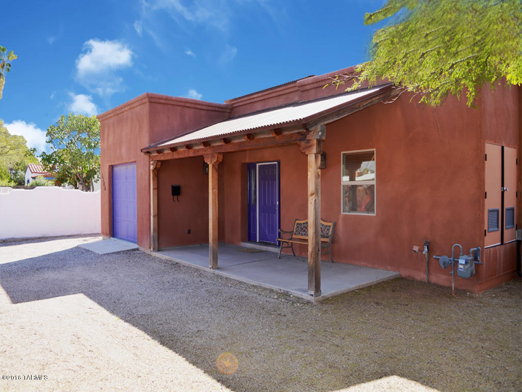 Centrally located Santa Fe stunner approx 2 miles from the University of Arizona. This newer 4 Bed/ 3 Bath home is beautifully appointed with stained concrete floors & ceramic tile throughout, stainless steel appliances, a spacious open floor plan, soaring wood plank living room ceilings with cozy fireplace, and large slider door that leads to the expansive wrap around covered back patio perfect for outdoor entertaining. Entry to the 1 Bed/1 Bath guest casita is also off the back patio. Enjoy this private tranquil backyard with mature trees and vegetation and large side yard. The front of the home has a decorative rustic metal fence that adds privacy and curb appeal. This property is perfect as a University rental or private home, strategically located in the heart of Tucson.