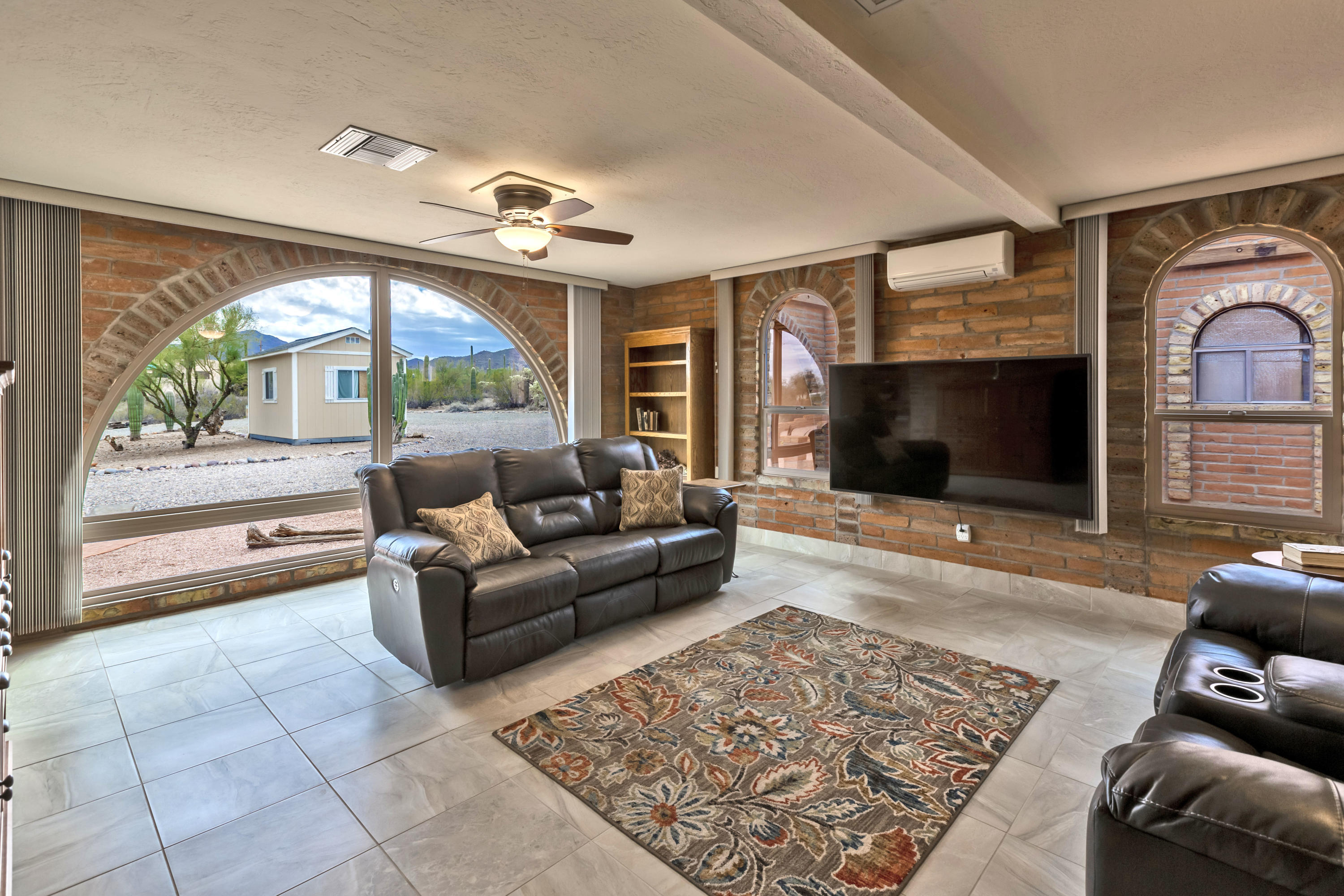 Burnt Adobe Tucson Territorial on 3.873 acres minutes w/City, Mountain & Desert Views. You can see the Santa Catalina, Rincon, Tortolita & Tucson Mountain Range all from your backyard. Beautiful City lights at night. Sunset & Sunrise view! Upgraded kitchen w/new Matte SS appliances. Beehive fireplace in living room. Large family room w/beautiful Arched window. Engineered Stone vanities and walk-in showers in both bathrooms. 3 car garage. New Milgard windows throughout the home. Enclosed Arizona Room. Large backyard with burnt adobe wall. MANY saguaros on the property. Storage Shed.