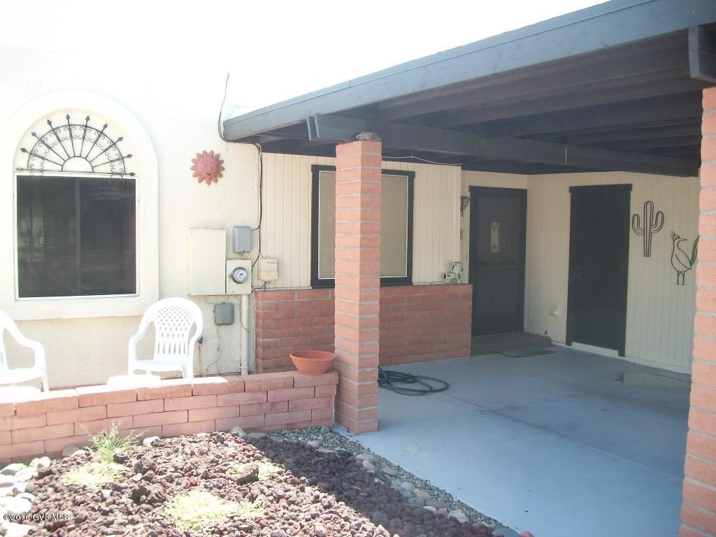 Lovely home. 1288 sq. ft. per appraisal. Furniture available SBOS. Backs up to the wash with a good distance between this home & home to rear. Mountain views. Roof replaced 2007, approx. cost $8000. HVAC replaced prior to 2007. Carport is 1 1/2 spaces wide.