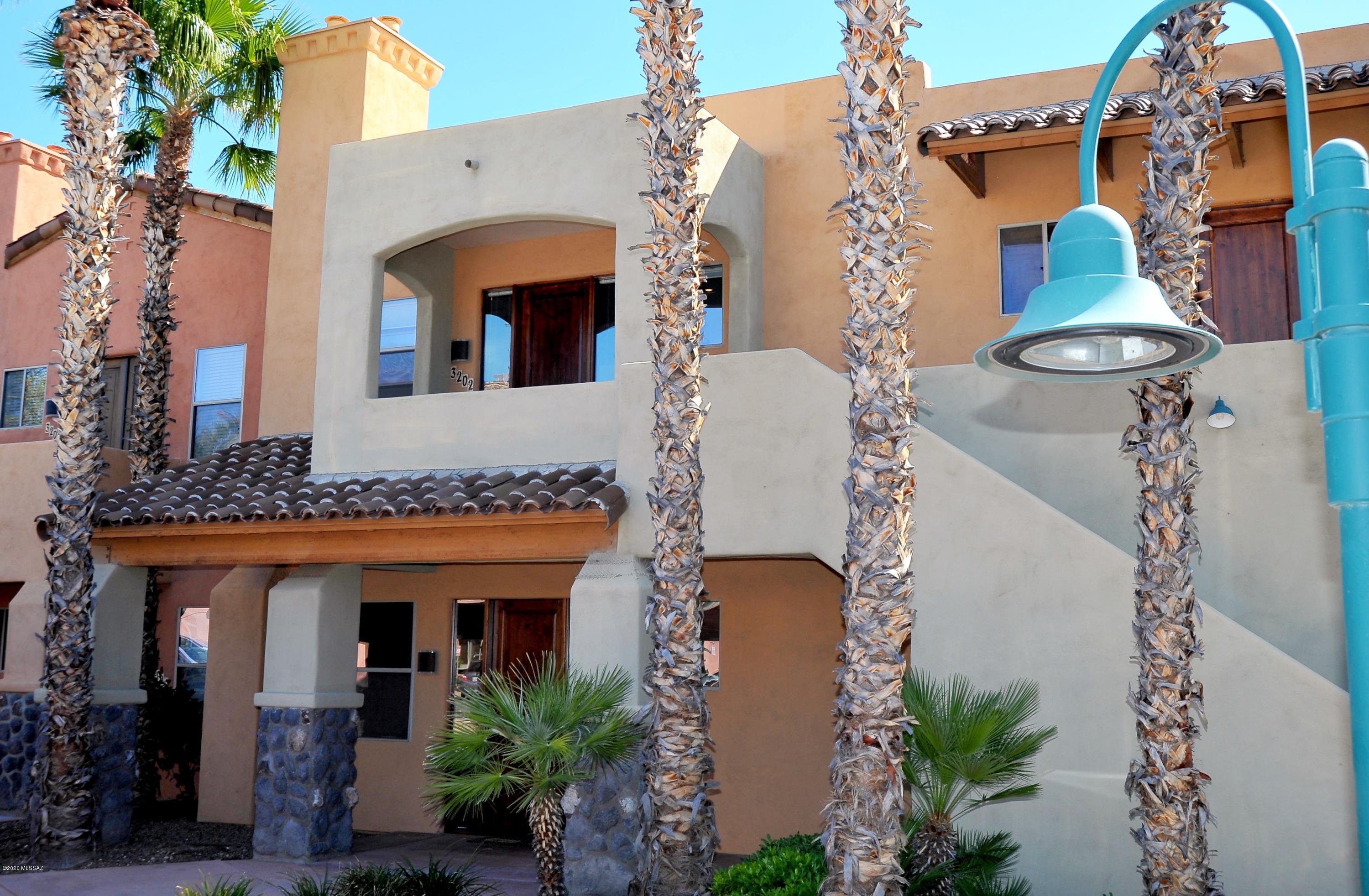 Location location! Updated move-in ready condo kitty-corner to UA! This 2nd level unit features gorgeous plank-style flooring in open concept living/dining area. Kitchen has SS appliances, tile counters and breakfast bar. Master bedroom w/ en-suite bath & 2 large closets. Spacious 2nd bedroom has a full bath right next door. Unit comes with washer/dryer. HOA includes roofs, exterior maintenance and water/trash.  On-site retail complex w/ Solari Day Spa, Trident Pizza Pub, Urgent Care, Toni & Guy, Pistache Gelato. Perfect for students, working professionals, snowbirds or rental. Furnishings are negotiable. Fireplace is decorative only.Two covered parking spots. Come see one of Tucson's premier urban lifestyle settings and enjoy all that the university/downtown area has to offer!