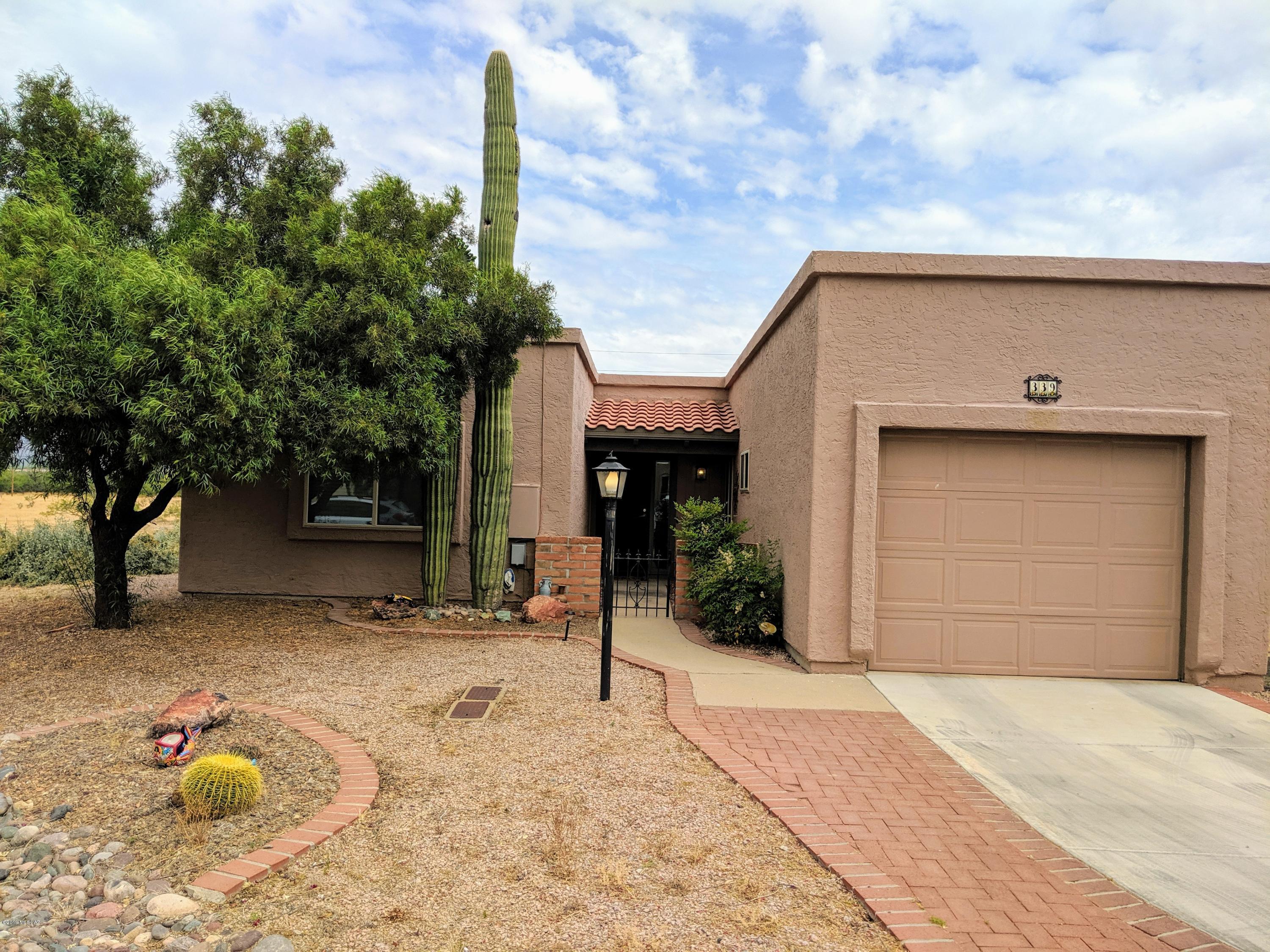 Beautiful home with amazing mountain views! The home is partially furnished and ready for your enjoyment. Updated throughout, including new heat pump for the central air, new carpet, new faucets on the kitchen and bathrooms, and professionally landscaped backyard. The covered patio overlooks the natural desert, framed by pecan trees and the Santa Rita Mountains, perfect for relaxing or entertaining. Close to the GVR centers, restaurants, shopping, golf courses. Come check it out today!