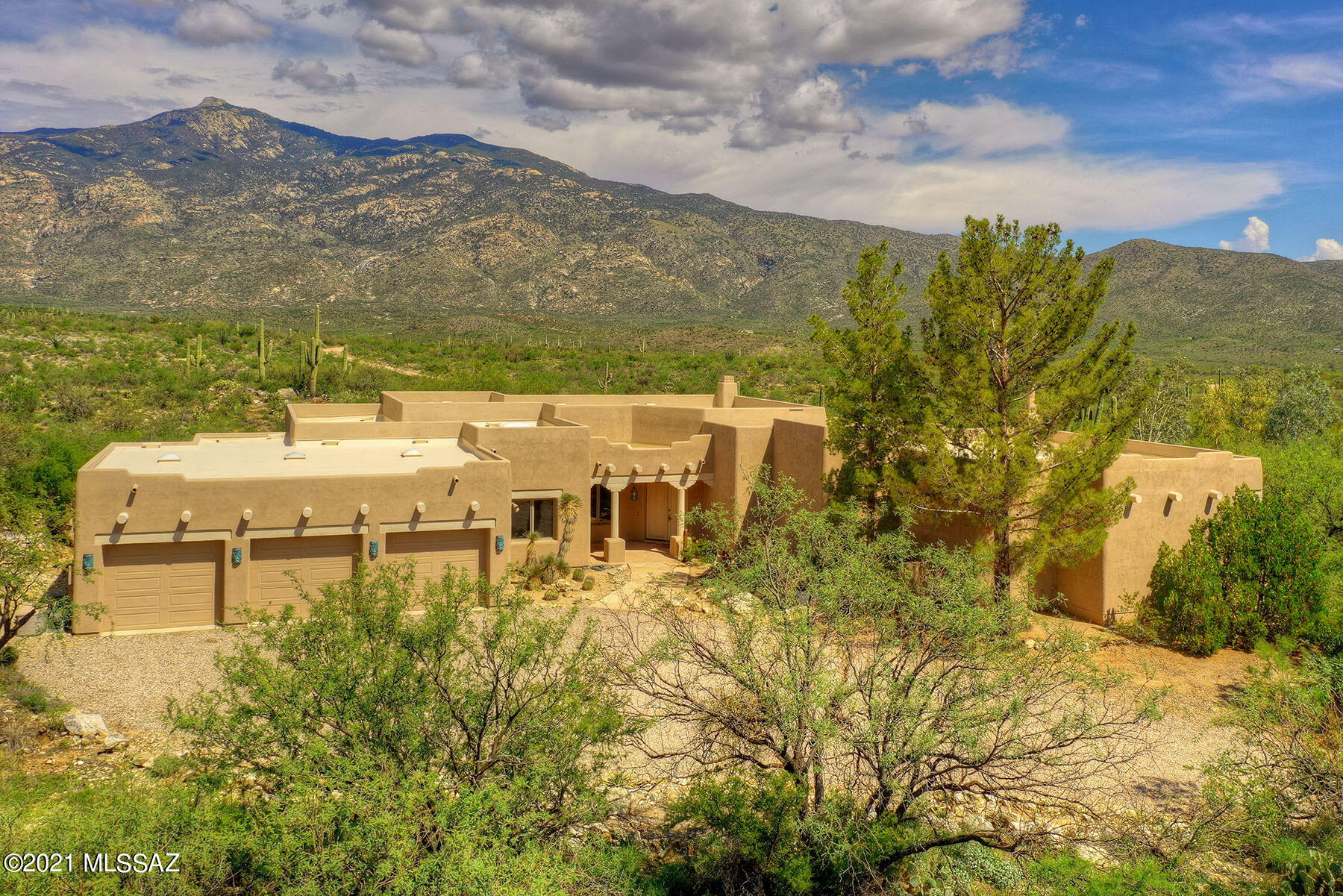 ''A River Runs Through It''  This truly stunning 3,709 sq. ft. Southwestern-style home is nestled on 45.5 heavily-wooded acres with Chimenea Creek running through it, conveniently bordering Saguaro National Park East.  The unique property is located in guard-gated X9 Ranch (minimum lot size in X9 Ranch is 36 acres) for the utmost privacy! Surrounded by waterfalls, majestic saguaros, towering mountains, a mesquite bosque, a boating area on the creek, and breathtaking Rincon Peak views. Highlights include a covered entry, a great room with walls of windows & a beehive fireplace, soaring viga beamed ceilings with corbels, flagstone flooring, Butler doors, art niches, and all wood-clad dual pane windows with cedar headers & rolling shutters.