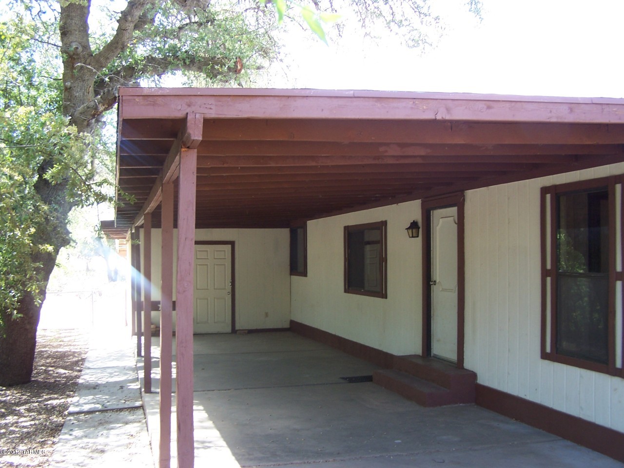 Two bedroom mobile in great condition, like new appliances, with large covered patio that extends all along the front, includes large storage/workshop, fenced yard w/ plenty of shade trees. Home is South facing for less sun exposure. $50 monthly water bill not included in rent amount. Owner/Agent