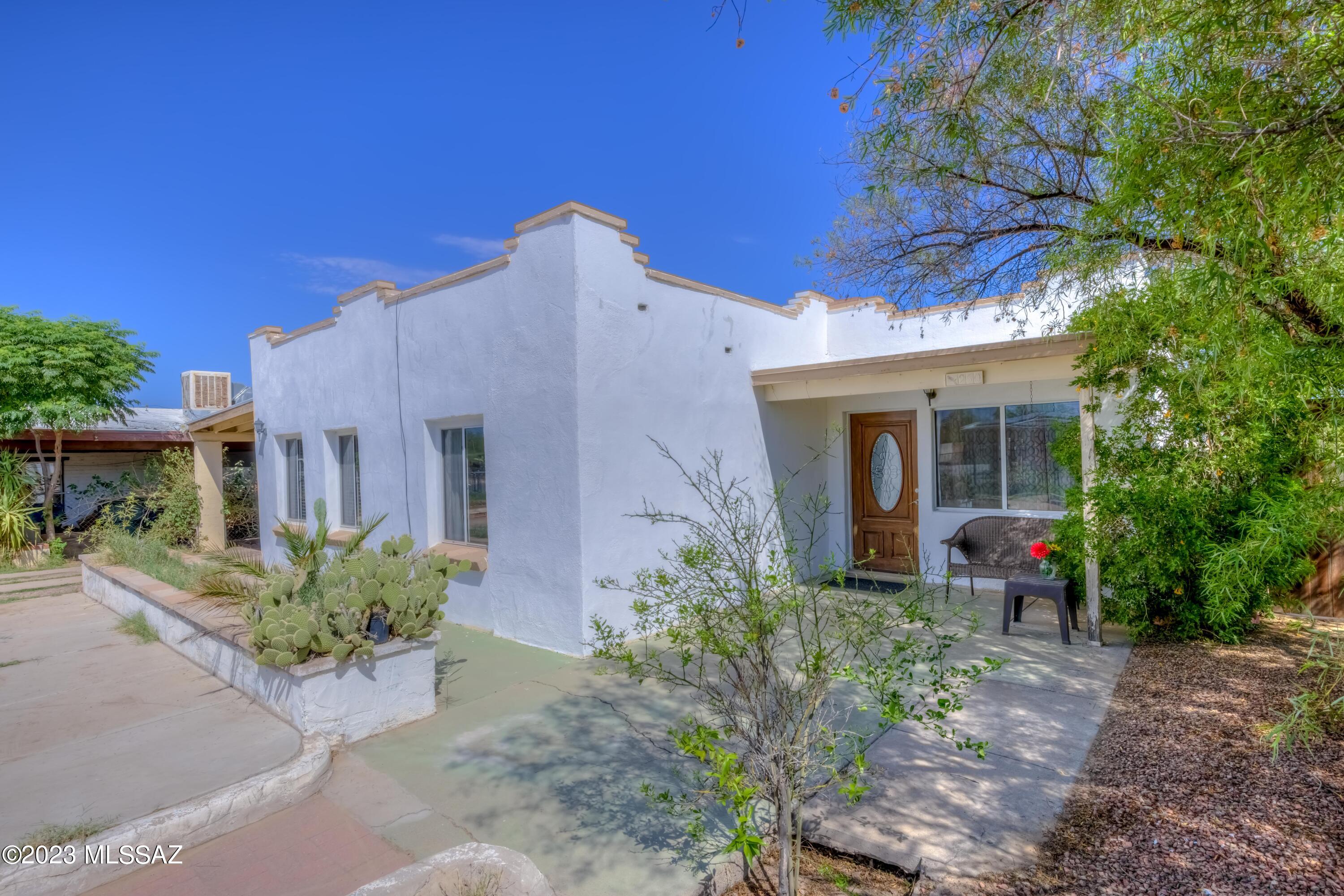 Great home in a well-established neighborhood! It features a large storage shed with electricity hooked up, could be used for a workshop, or can possibly make for a future guest house. Solar panels, newer double pane windows, recessed lighting, ceiling fans, tile and laminate flooring throughout. No carpet! Nice back covered patio with pavers. Flower beds in front yard.  Electric wrought iron gate for privacy and security, and a large metal pergola. Property offers easy access to I-19, Spectrum mall, restaurants, VA hospital and public transportation. This home won't last!