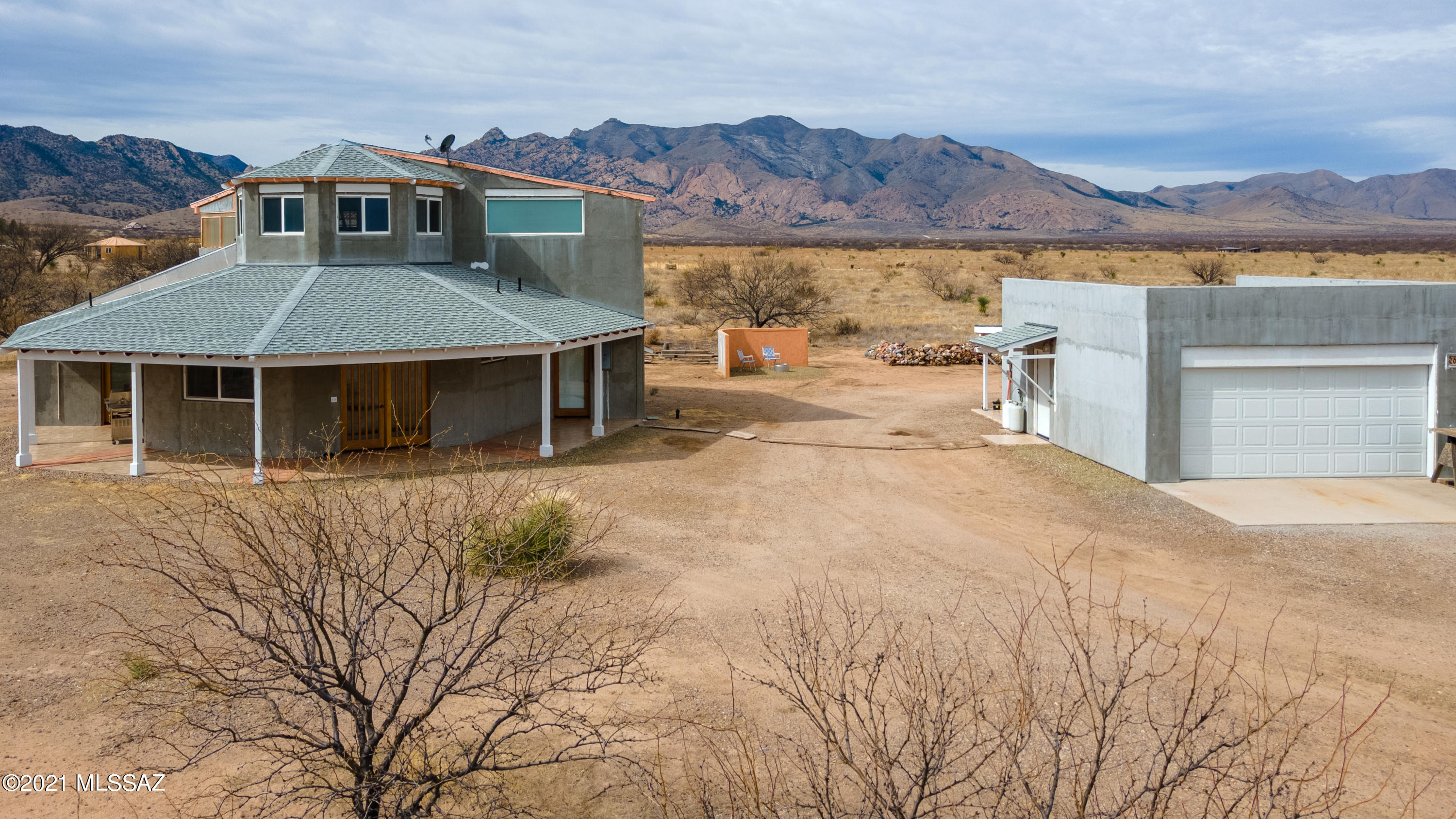 Million Dollar Views at an affordable price.  This custom built home located just 20 minutes off of I-10 is waiting for you to put the finishing touches on it to make it your dream home.  The wide open floor plan and beautiful wood beams make the main level very inviting.  Stay warm in the winter by the economical pellet stove.  The upstairs features a loft and master suite with walk-in tile shower and an exterior balcony to soak in the views!  The detached 2 car garage also features a full bathroom, perfect for the project enthusiast.  RV Hookup is available as well to welcome out of town guests.  So many thoughtful features in this home like the higher custom kitchen cabinets - save your back when doing dishes!  Come see the magic of this stunning property.