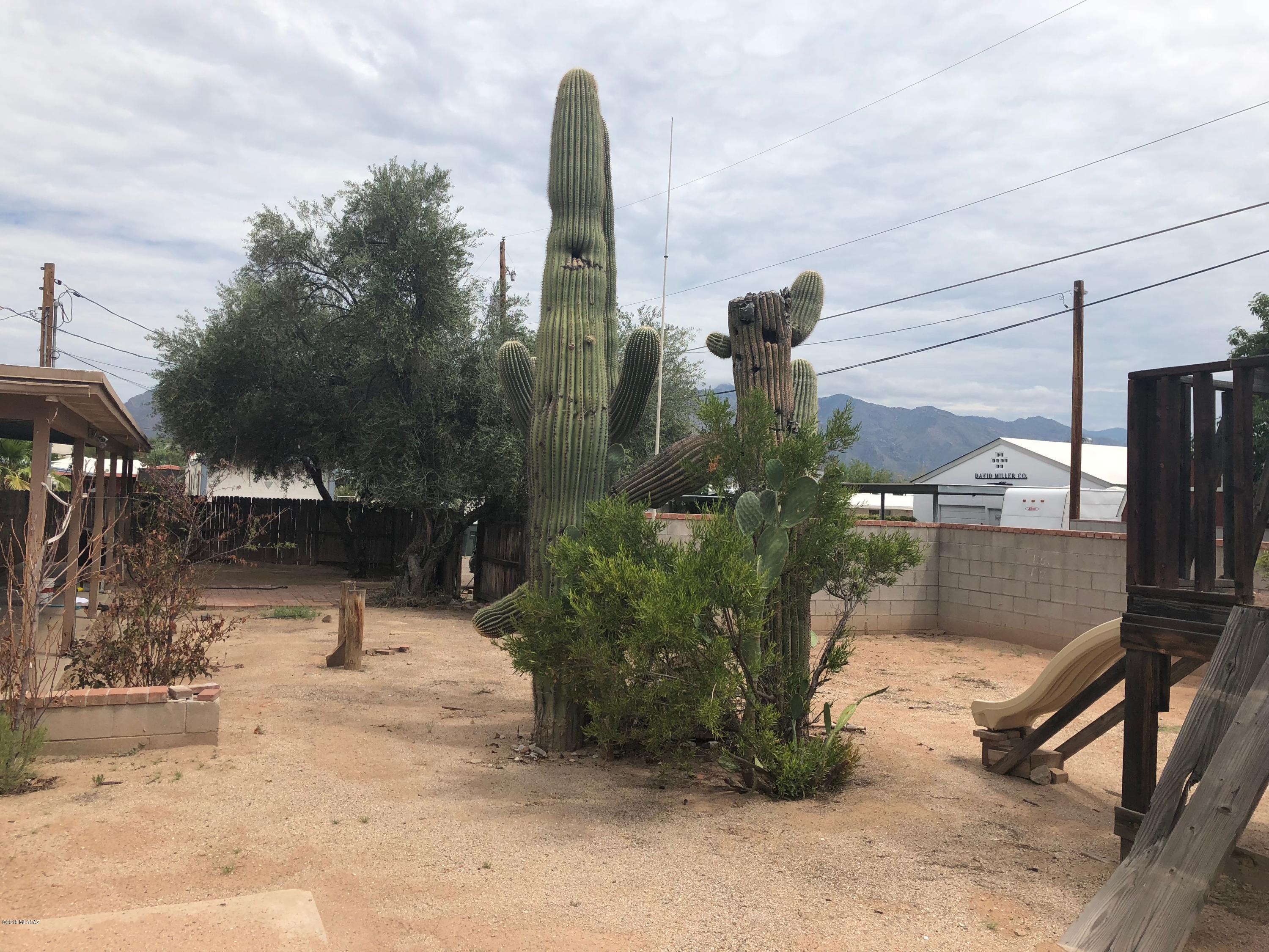 Motivated seller! Make an offer. 
Wonderful Central Location C-1 Lot with 2 br, 2 ba front house, with a one br, 1 ba guest quarters with separate entrance. Could be made to be one house very easily. Or rent one and live in the other. Nice big lot.
Lots of room in central Tucson for so many options for use. There is another lot behind this lot that could be included in this sale. Call for more details. Would be .35 of an acre total giving you a lot of options.