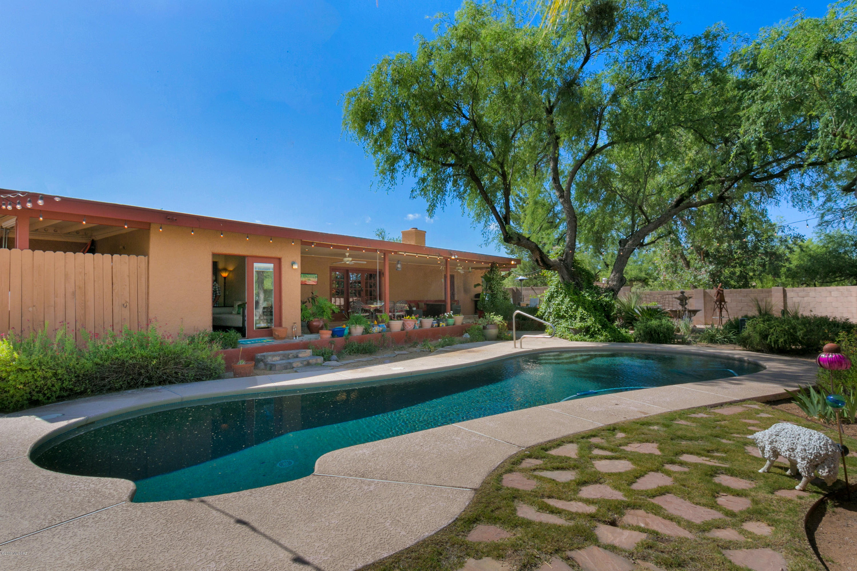 Majestic mountain views are showcased from every room in this special 4 BR/2 BA home nestled amidst lush mesquite trees on over an acre of horse property. Attention to detail and designer touches throughout. Pristine home that has been updated to today's modern elegance. Deluxe kitchen with granite countertops, tile accent backsplash and SS appliances. Gracious master suite has sitting room, private patio and barn door to bathroom. Master bath room freshly renovated with vessel sinks, walk in shower with subway and mosaic tile and glass wall. Enjoy outdoor living with tantalizing pool, expansive covered patio, serene fountain make this a desert oasis. Studio could be workshop or guest house.  Horse corrals with covered area electric, water and tack & hay barn. Voluntary HOA