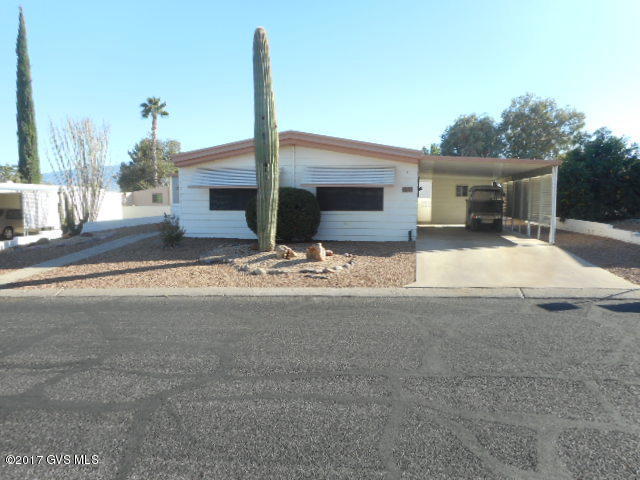 Well maintained home, not too far from the Rec Center. Solar Screens all around main part of home. Screen porch to enjoy the views of mountains, sunrises and sunsets. Well sized workshop with storage shelves and workbench for tinkering. Furnace, A/C and Water Heater have been replaced. New flooring in hall and both bathrooms. Toilets, fixtures and sinks replaced in bathrooms along with sink in kitchen. Light panel throughout. Kitchen has lots of cabinets. Large walled in backyard, Easy care landscaping. HOA Fee $55.00 mo. includes clubhouse, spa, library, meeting room, exercise room, pool tables, horseshoes, shuffleboard courts, ceramics, crafts, card games, bingo, monthly newsletter, trash pick up and road maintenance. Close to restaurants, shopping, doctor offices and golf courses.