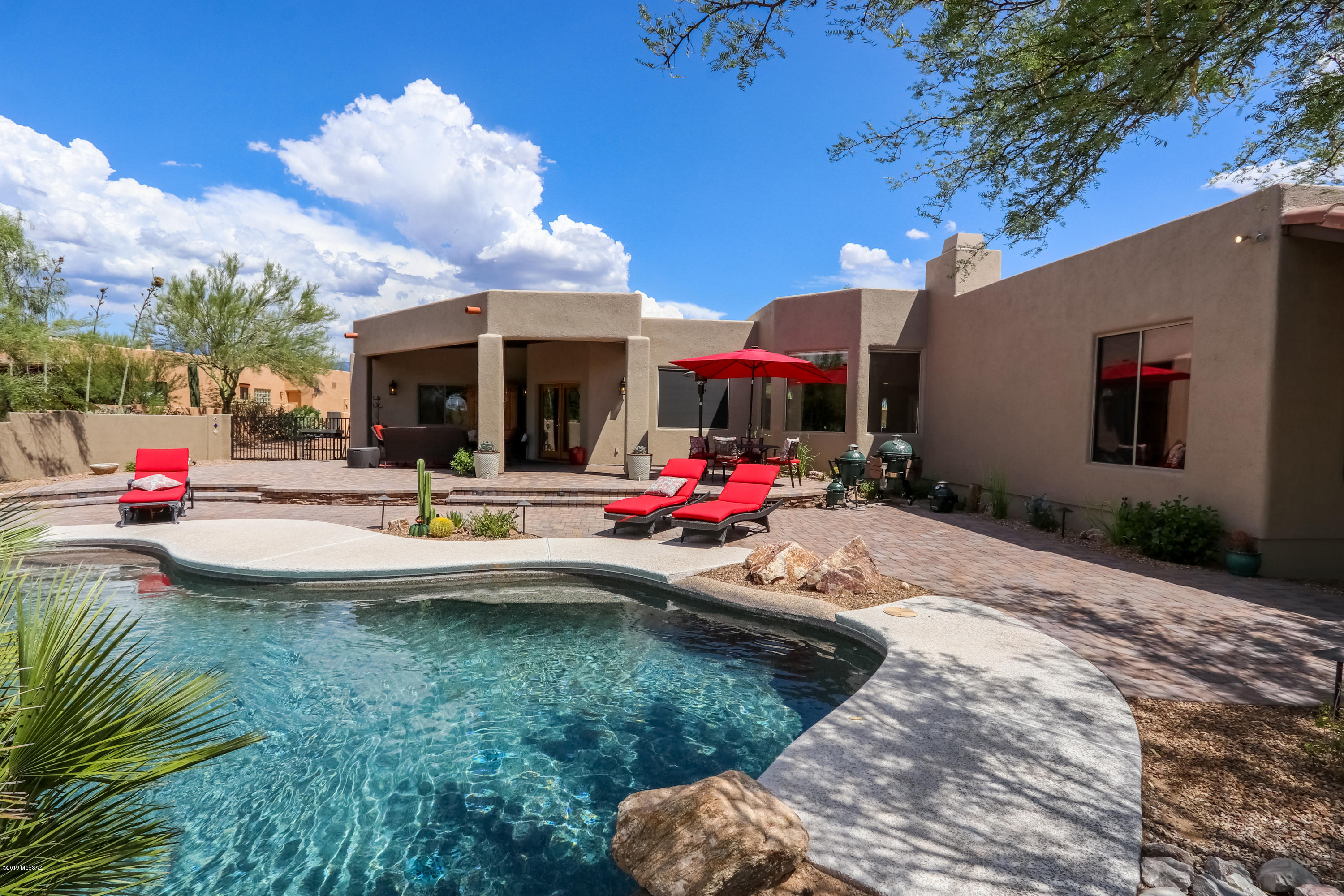 Seller will accept or counter offers between $500,000 and $515,000. LOCATION, LOCATION, LOCATION! Come visit this gorgeous home in one of Oro Valley's gated communities! Featuring a spacious three-car garage, attractive desert-friendly landscaping, and a huge walled backyard, this half acre property offers privacy and beauty. Relax and enjoy your professionally landscaped backyard with a shaded patio and pool with waterfall. This property is perfect for entertaining guests and family. The home features beautiful hardwood floors and a gas fireplace, in addition to a large kitchen with a breakfast bar, island, and a walk-in pantry with plenty of storage space. You'll fall in love with this stunning, unique home, so act fast and book your showing today! Owner/Agent.