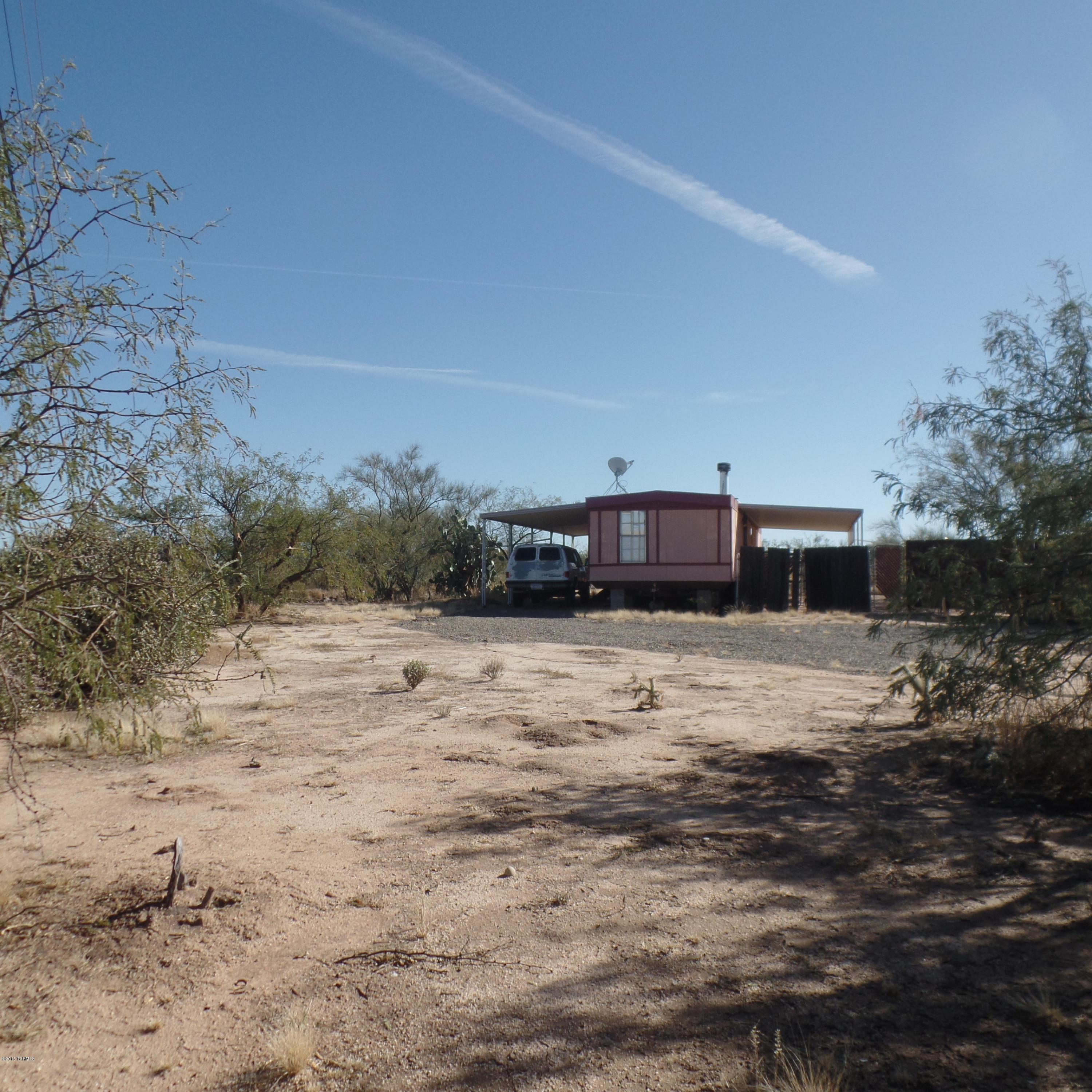 One acre of horse property and a great starter home to go with it. The coyotes will sing you to sleep after enjoying amazing sunset views. Take your time down the dirt road and the drive will be worth it.