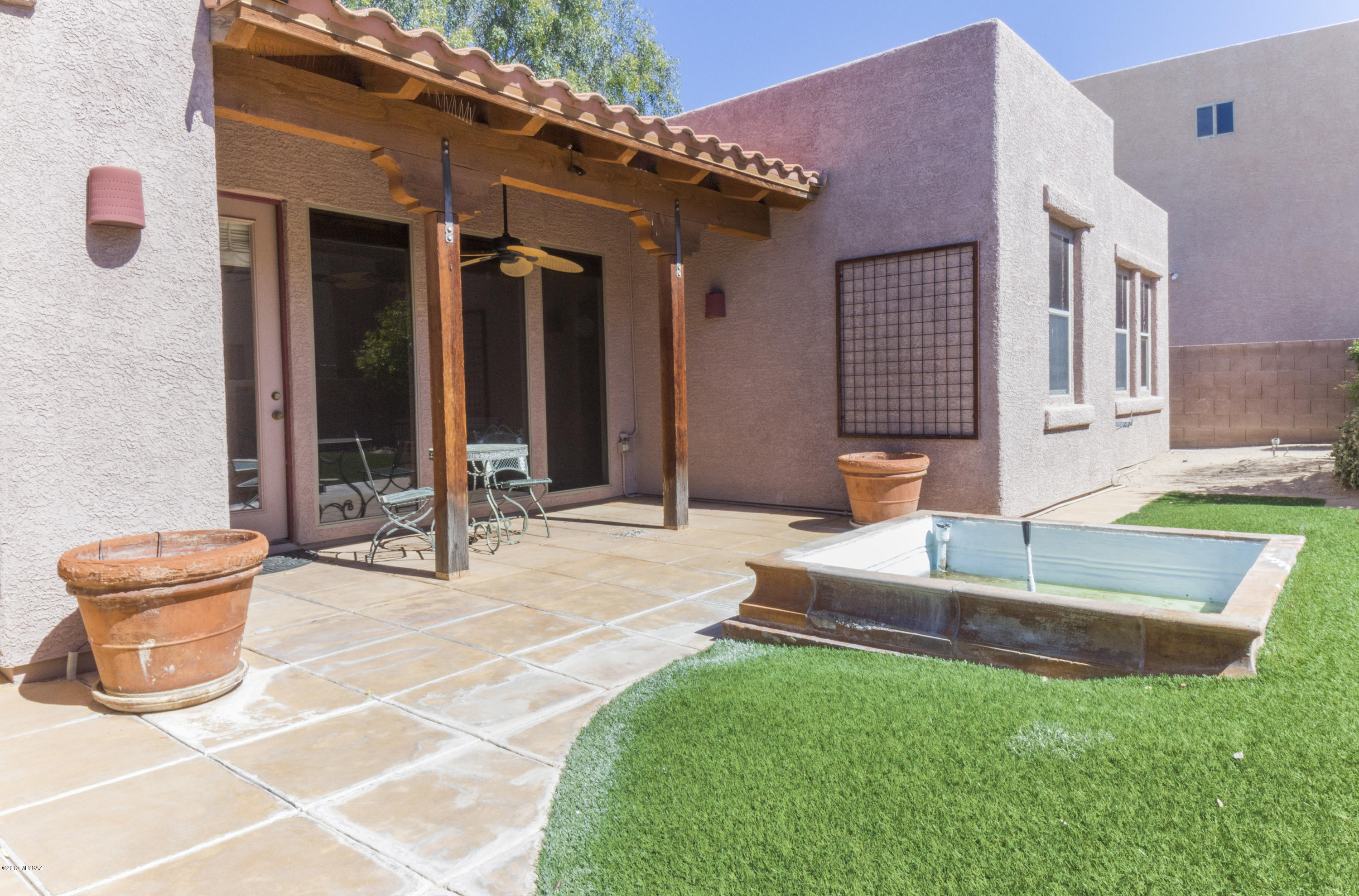Fantastic well cared for home in this private central neighborhood.  Features a stunning greenroom with open floorplan design and large bedrooms with a well appointed master suite.  The yard is a stunning oasis with a private fountain, covered seating area, and low care trees granting even more privacy.  A seperate courtyard off the kitchen offers additional outdoor living or a convenient barbeque area.  Modern living in central Tucson at its finest you dont want to miss this!
