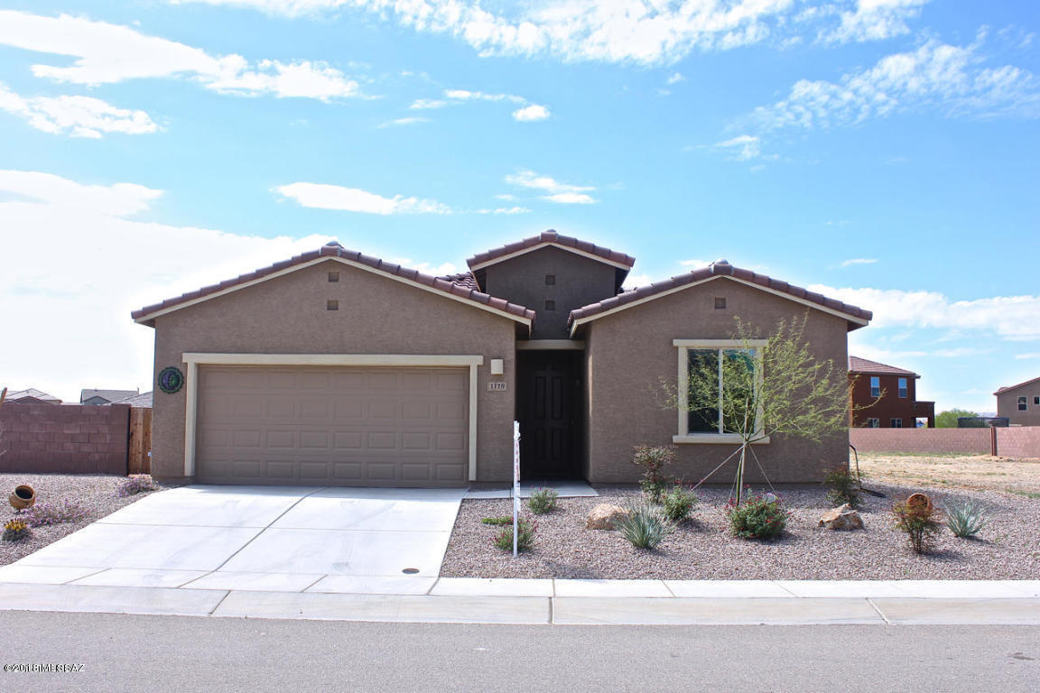 This 4 bed/2 bath Meritage home is a popular split floor plan, has an extended 4' in the garage, gorgeous, richly colored cabinets with wireless under-cabinet lights, upgraded fixtures in the kitchen, a bay window overlooking the lagoon entry-style pool in the backyard, and an island bar for entertaining. One of the largest lots in Madera Highlands Village. Outside you will find an enormous backyard, with mountain views, a covered patio (with gas stub for a grill), and beautiful Pebble Tec pool.  Owners have also put in sod, a fence for the pool, and paver landscaping. The Madera Highlands community offers a pool, multiple parks, tennis court, basketball court, and a dog park. Come and make it your next home!