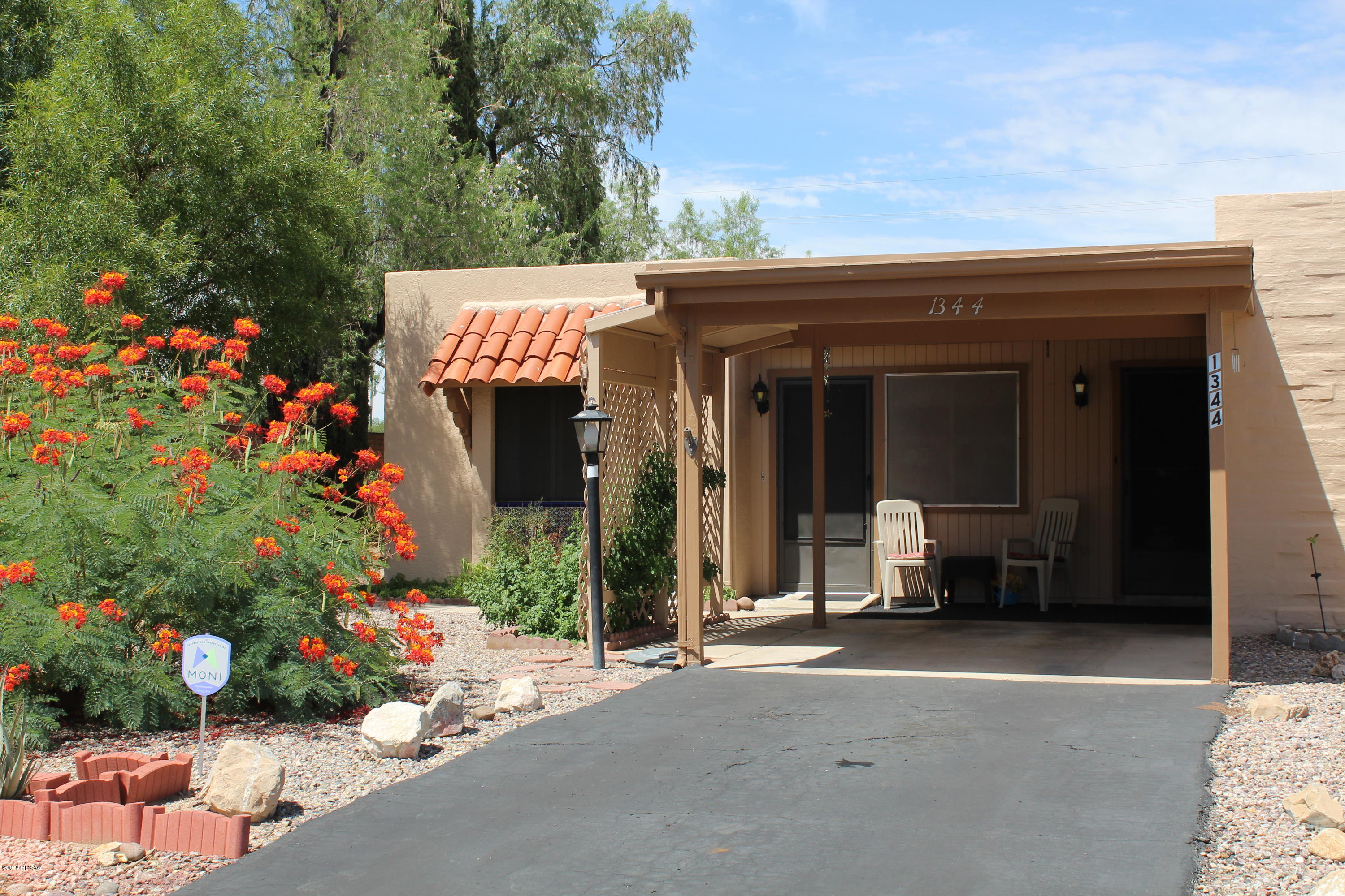 This private end unit offers more outdoor space than most in this neighborhood, with trees, fruit trees and other low care plantings.  Sit outside to enjoy this space and tranquility.  Inside an Arizona room and small dining area was added shortly after construction offering 1,075 sq. ft. as determined by a recent appraisal.  This 2 bedroom home actually can boast 2 masters as the guest room has it's own bath.  Brand new dishwasher (just installed/never used), master shower is tiled, laundry in the kitchen pantry.  Close to GVR Rec centers, shopping and other businesses.