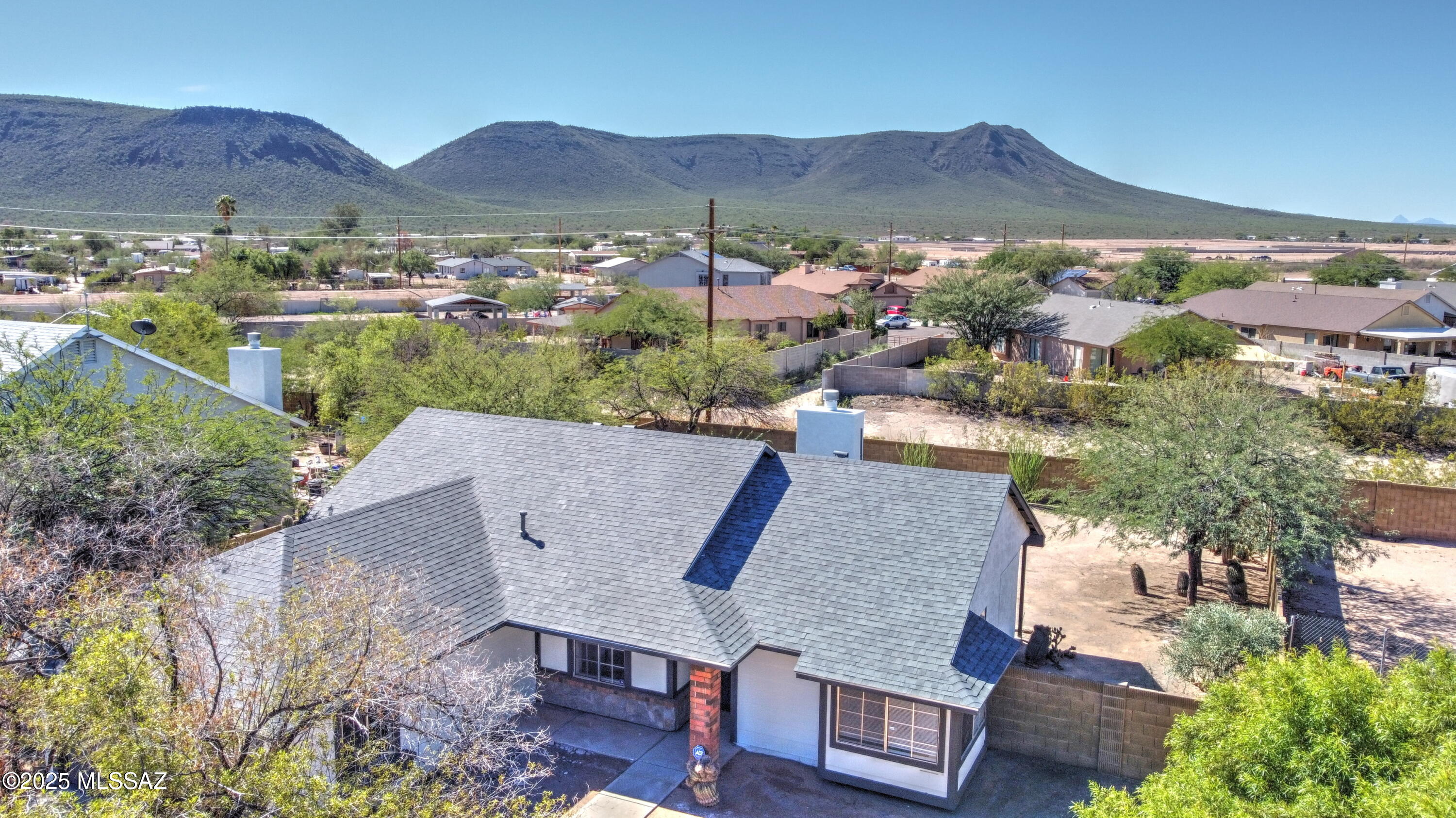 MOUNTAIN VIEWS! Welcome to this beautiful 3-bedroom, 2-bath home featuring a layout designed for easy, comfortable living. Inside, the bright and airy living room showcases a wood-burning fireplace that creates a warm and inviting atmosphere. The home has been refreshed with all new floor tile, new carpet in the bedrooms, new lighting throughout, and fresh interior and exterior paint. The 2-car garage features a newly epoxy-coated floor and a serviced garage door for added convenience. The home also includes new roof shingles installed in 2025.  Outside, enjoy the newly added decorative rock and updated front landscaping, complemented by mature desert plants and breathtaking mountain views. Electric Range and dishwasher will be installed before close of escrow. Owner agent